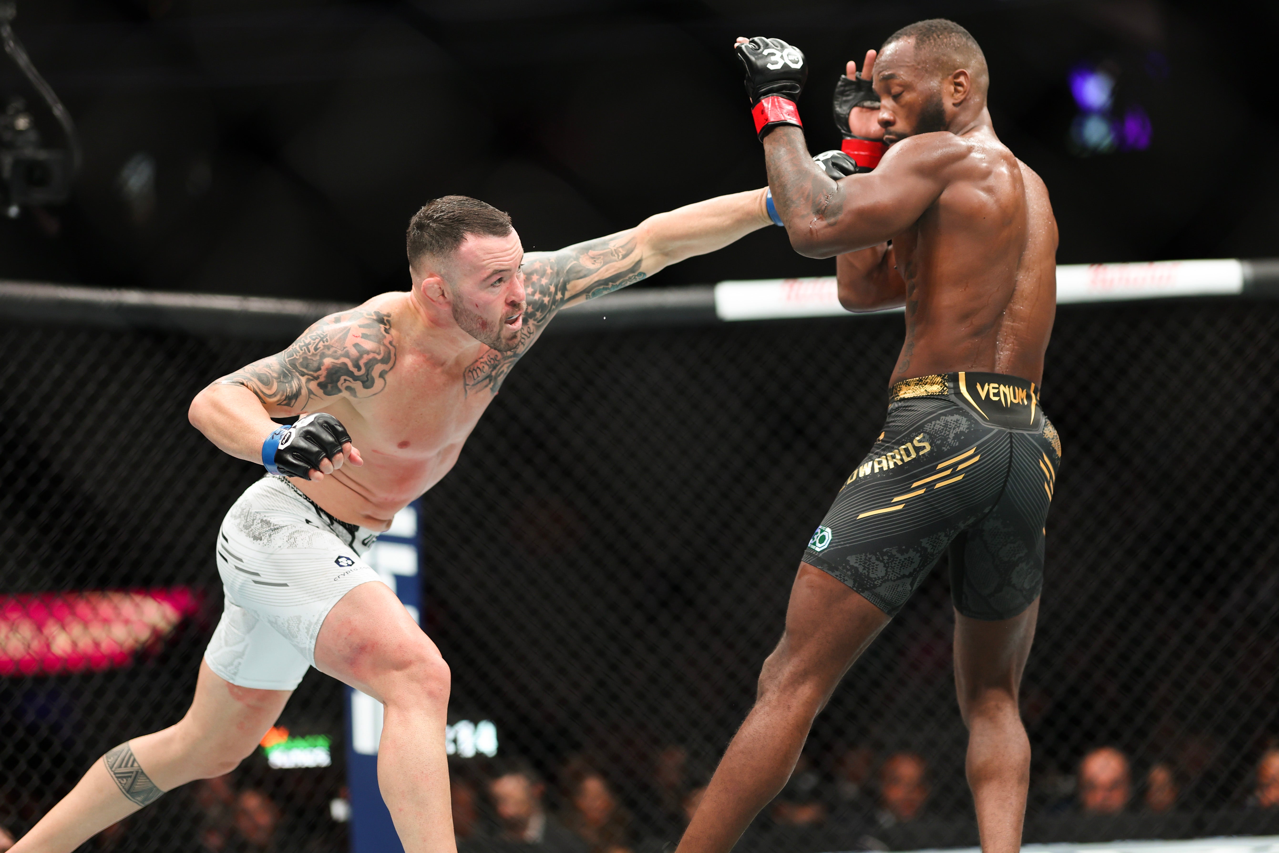 Colby Covington struggles to close distance to Leon Edwards (right)