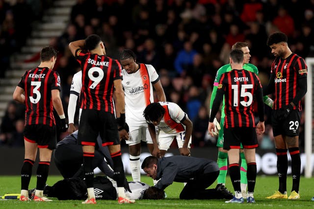 <p>Luton’s Tom Lockyer receives treatment on the pitch during the Premier League match at Bournemouth</p>