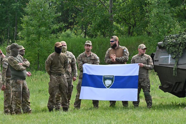 <p>File: A deputy commander for the Freedom of Russia Legion, who gave his call sign as Caesar, stands with fellow fighters during a presentation for the media in northern Ukraine, not far from the Russian border, on 24 May 2023</p>
