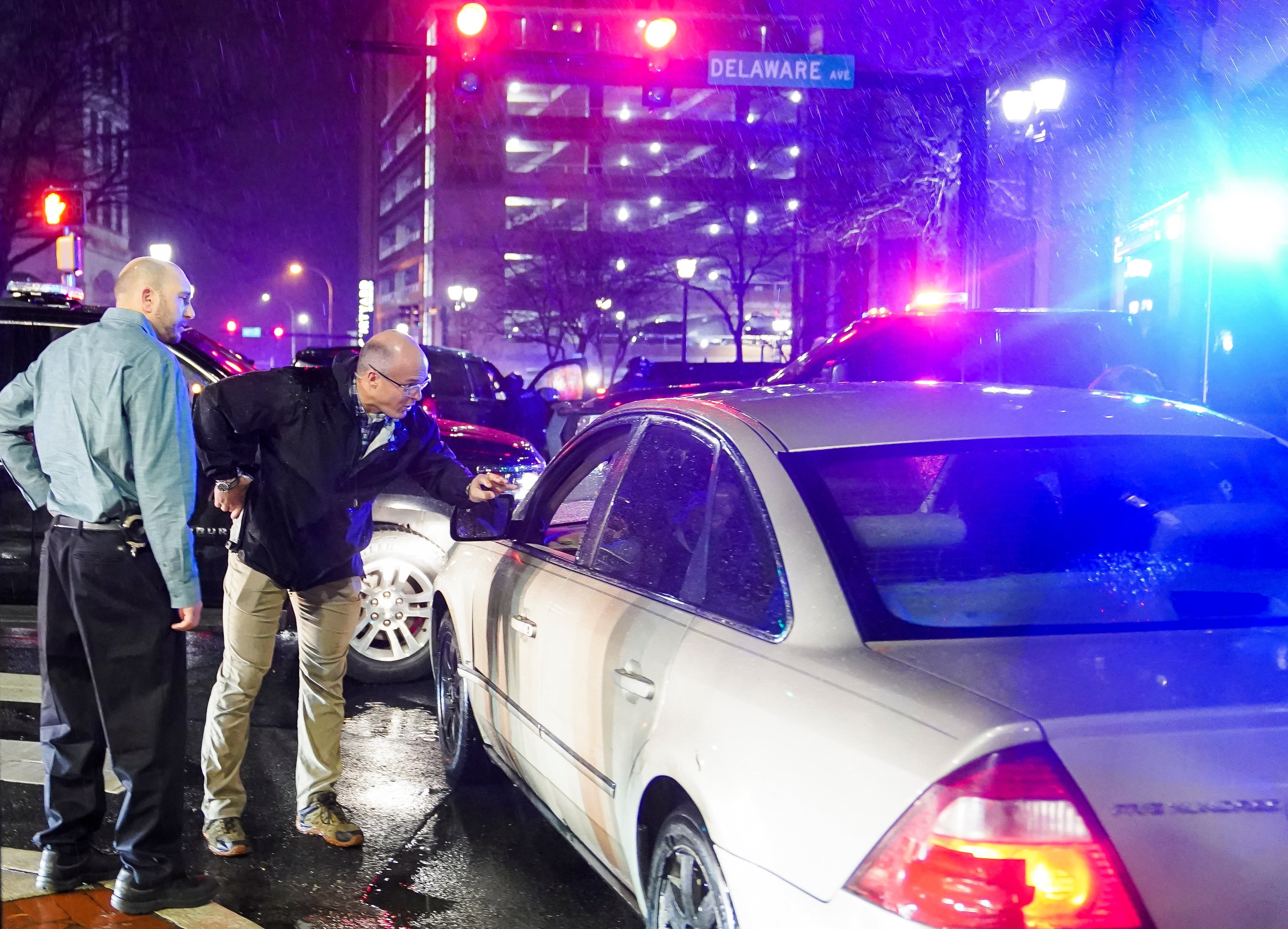 Members of the United States Secret Service speak to the driver of the vehicle that crashed into a Secret Service SUV that was blocking the street as U.S. President Joe Biden exited his campaign headquarters, in Wilmington, North Carolina, U.S. December 17, 2023