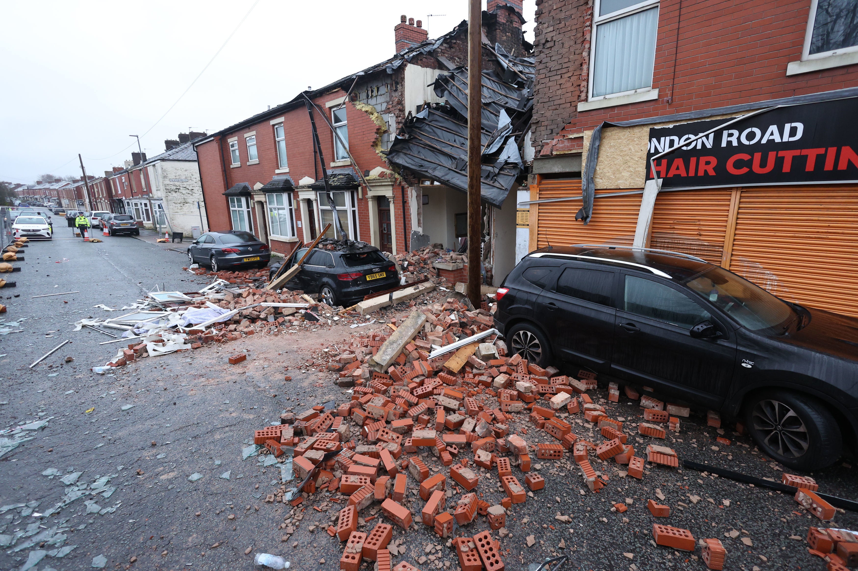 Debris litters the road and pavement in London Road, Blackburn, Lancashire