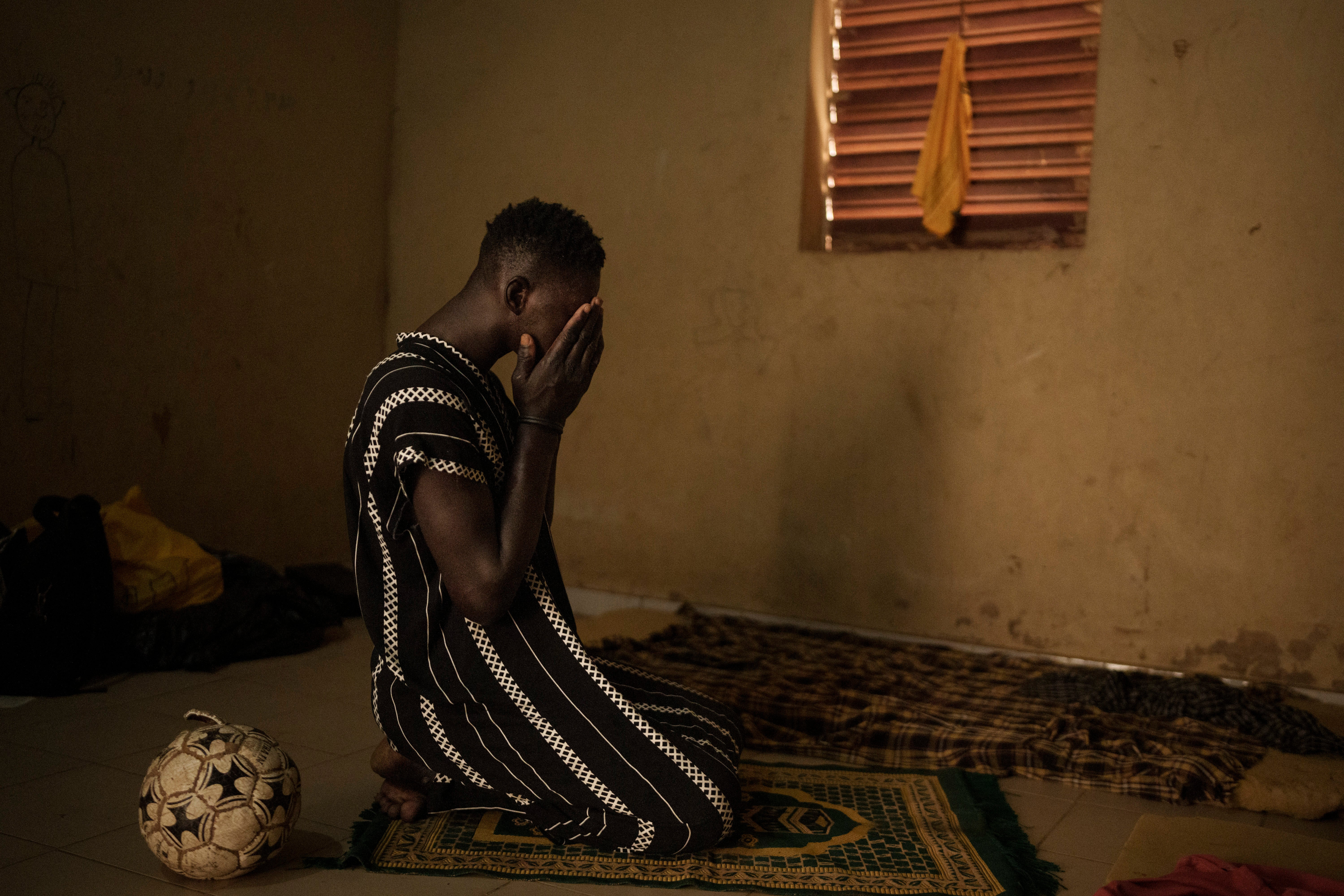 Papa Dieye, 19, prays in his father???s home in Diogo, Senegal, Monday, Aug. 28, 2023.
