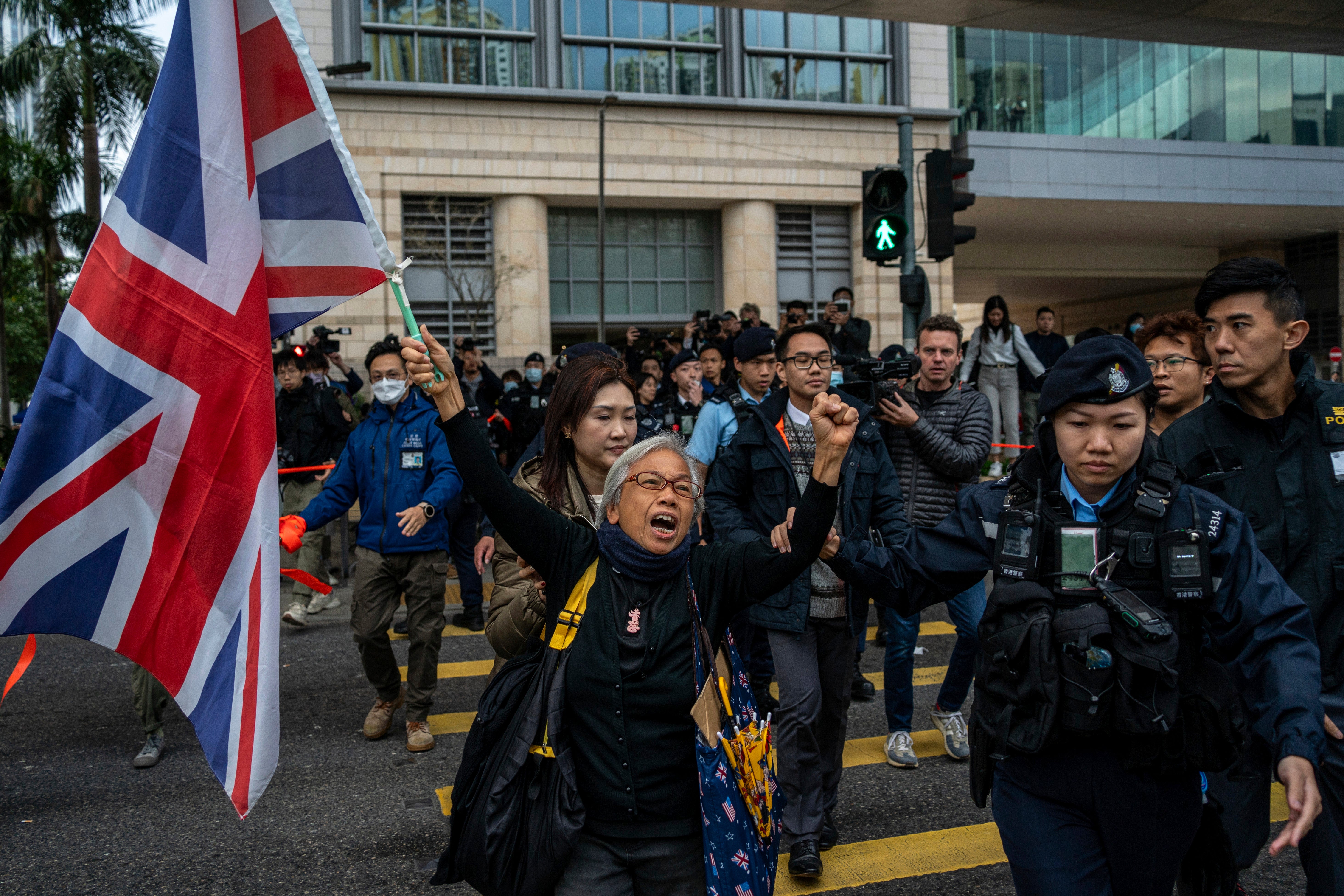 Activist Alexandra Wong, also known as Grandma Wong, holds a British flag outside the West Kowloon Law Courts
