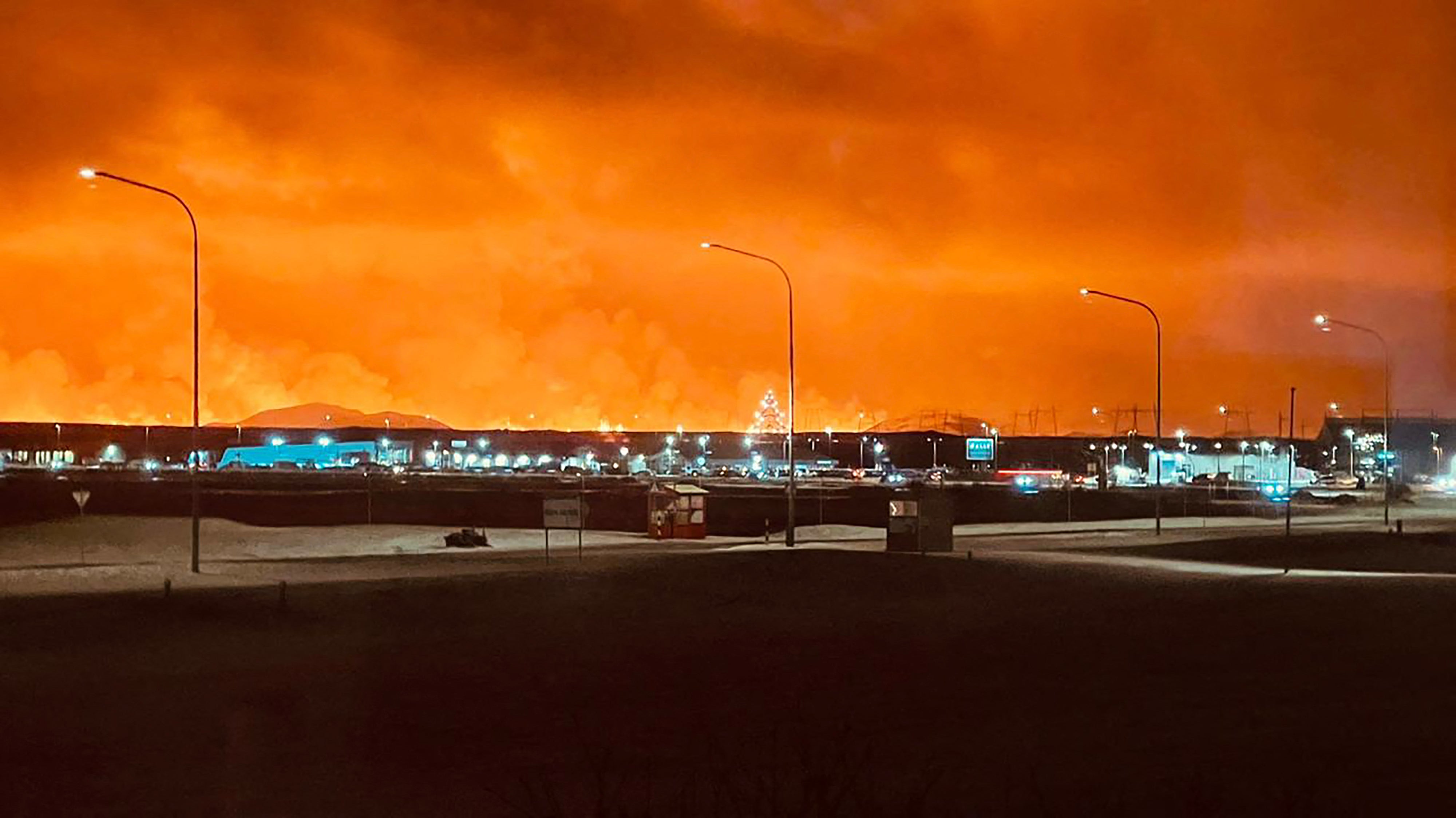 <p>Roads in the town of Keflavik are pictured as smoke billow with lava colouring the night sky orange from an volcanic eruption on the Reykjanes peninsula</p><p>” top=”2250″ width=”4000″ structure=”responsive” i-amphtml-layout=”responsive”><i-amphtml-sizer slot=