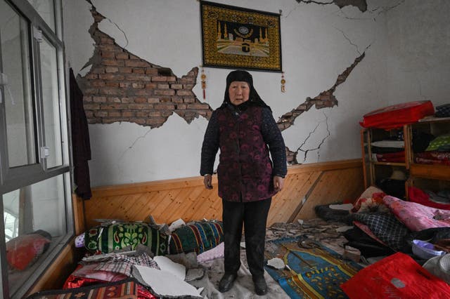 <p>A woman shows the damage to her home after an earthquake in Dahejia, Jishishan County in northwest China's Gansu province</p>