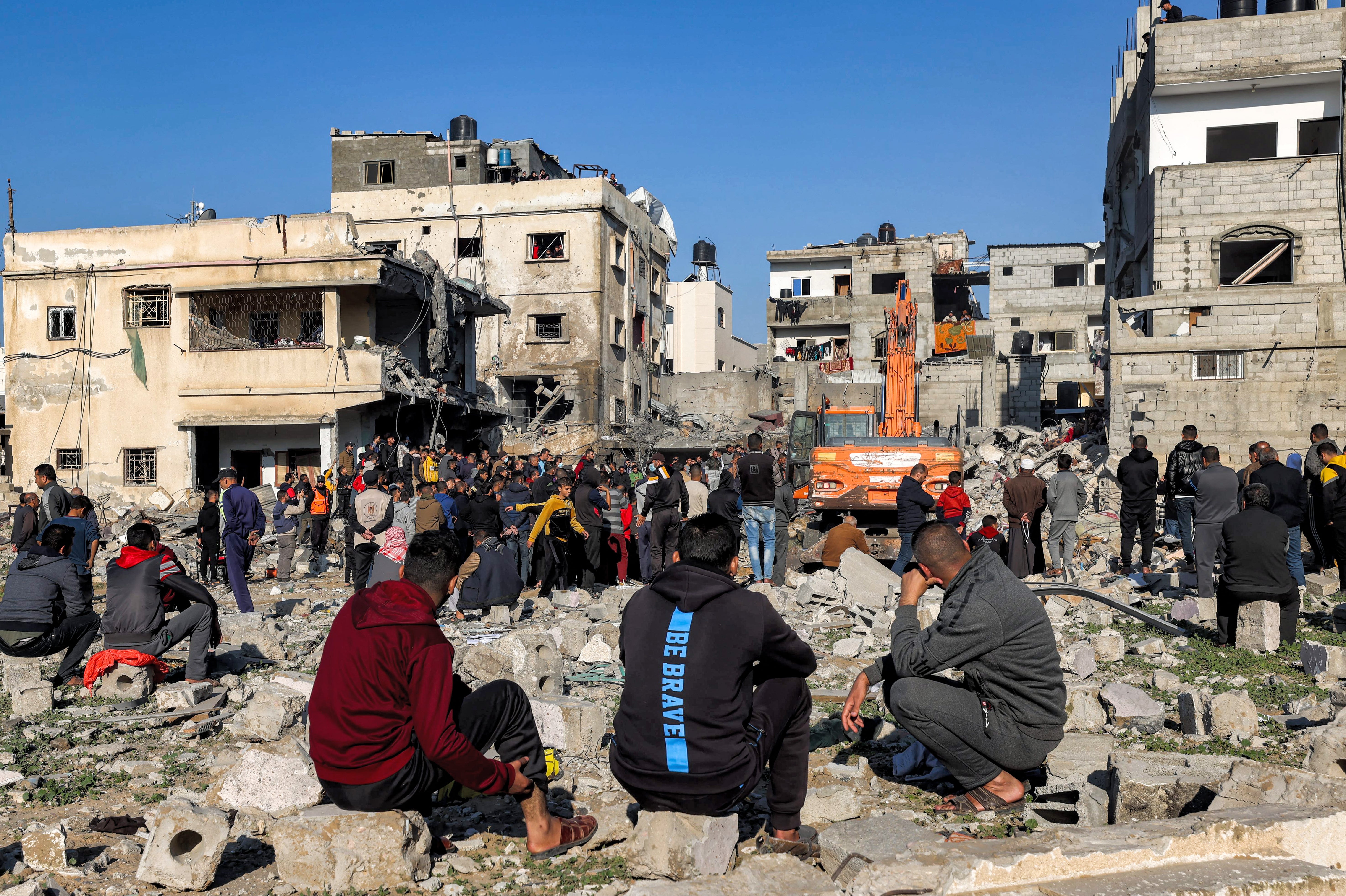 Excavators dig through the rubble of a building destroyed by Israeli bombardment in Rafah in the southern Gaza Strip