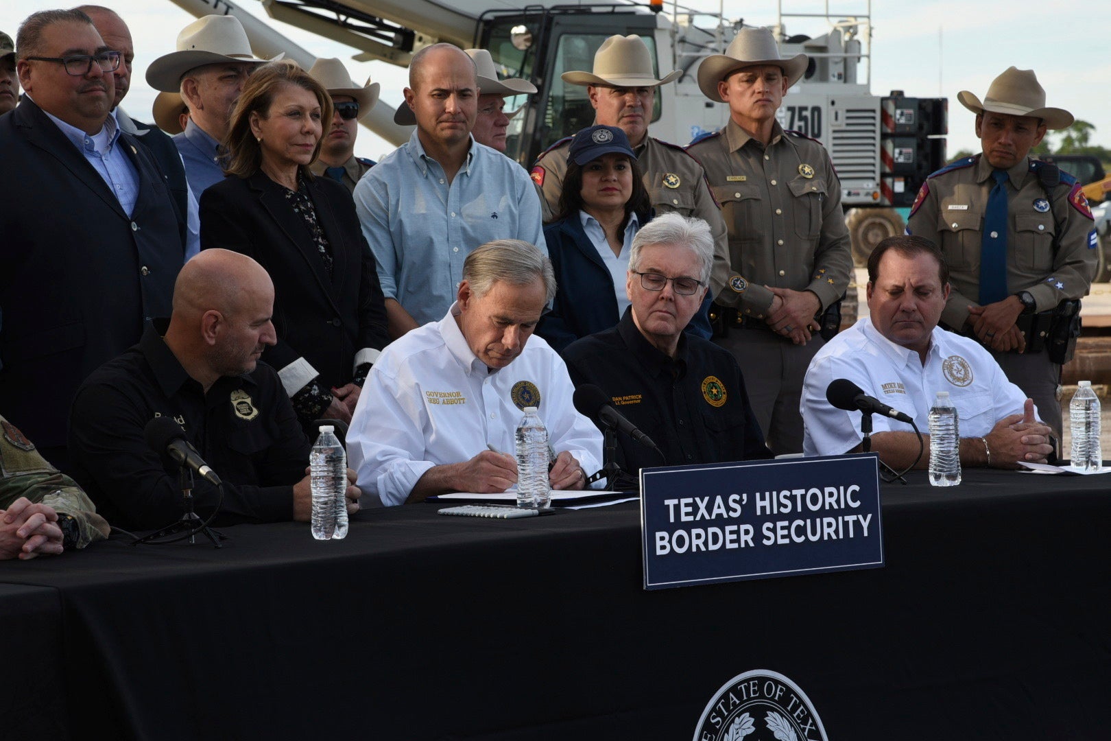 Gov. Greg Abbott signs three bills into law at a border wall construction site in Brownsville, Texas on 18 December that aims to deter illegal immigration