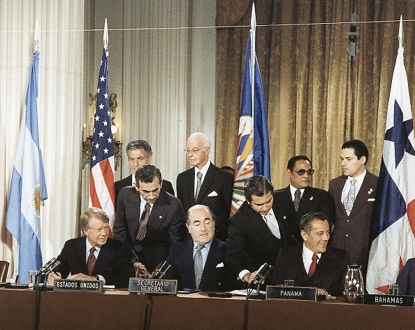 This September 7,1977 photo shows (seated L-R) former president Jimmy Carter, Organisation of American States (OAS) secretary general Alejandro Orfila, and Panamanian president Omar Torrijos attending the signing of the Carter-Torrijos Treaty at the OAS in Washington, D.C.