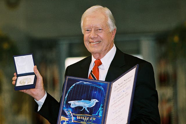 <p> Former president Jimmy Carter holds up his Nobel Peace Prize December 10, 2002 in Oslo, Norway.  His granson said he is no longer awake every day while in hospice care.  </p>