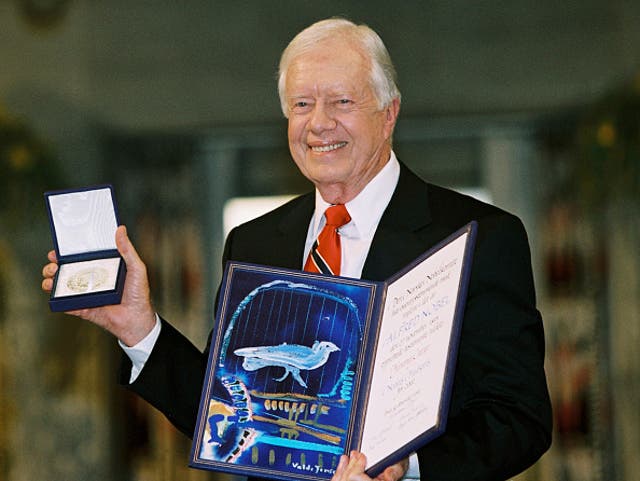 <p> Former president Jimmy Carter holds up his Nobel Peace Prize December 10, 2002 in Oslo, Norway.  His granson said he is no longer awake every day while in hospice care.  </p>