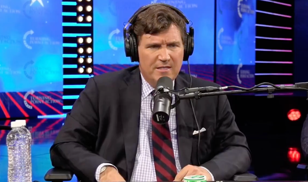 Tucker Carlson during a live discussion hosted by Tim Pool at Turning Point USA’s AmericaFest