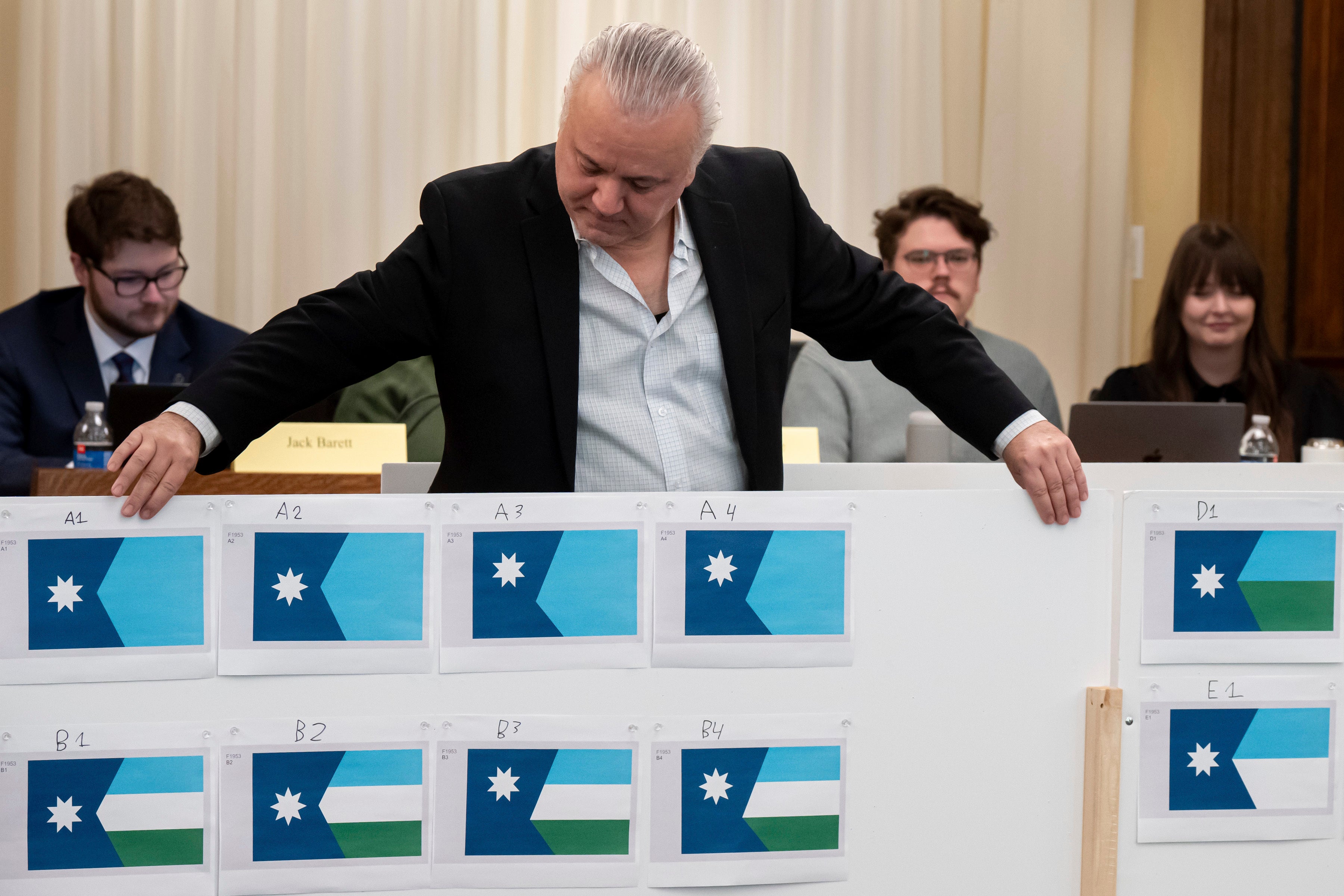 Minnesota's flag commission Chair Luis Fitch adjusts some of the final designs as the commission meets