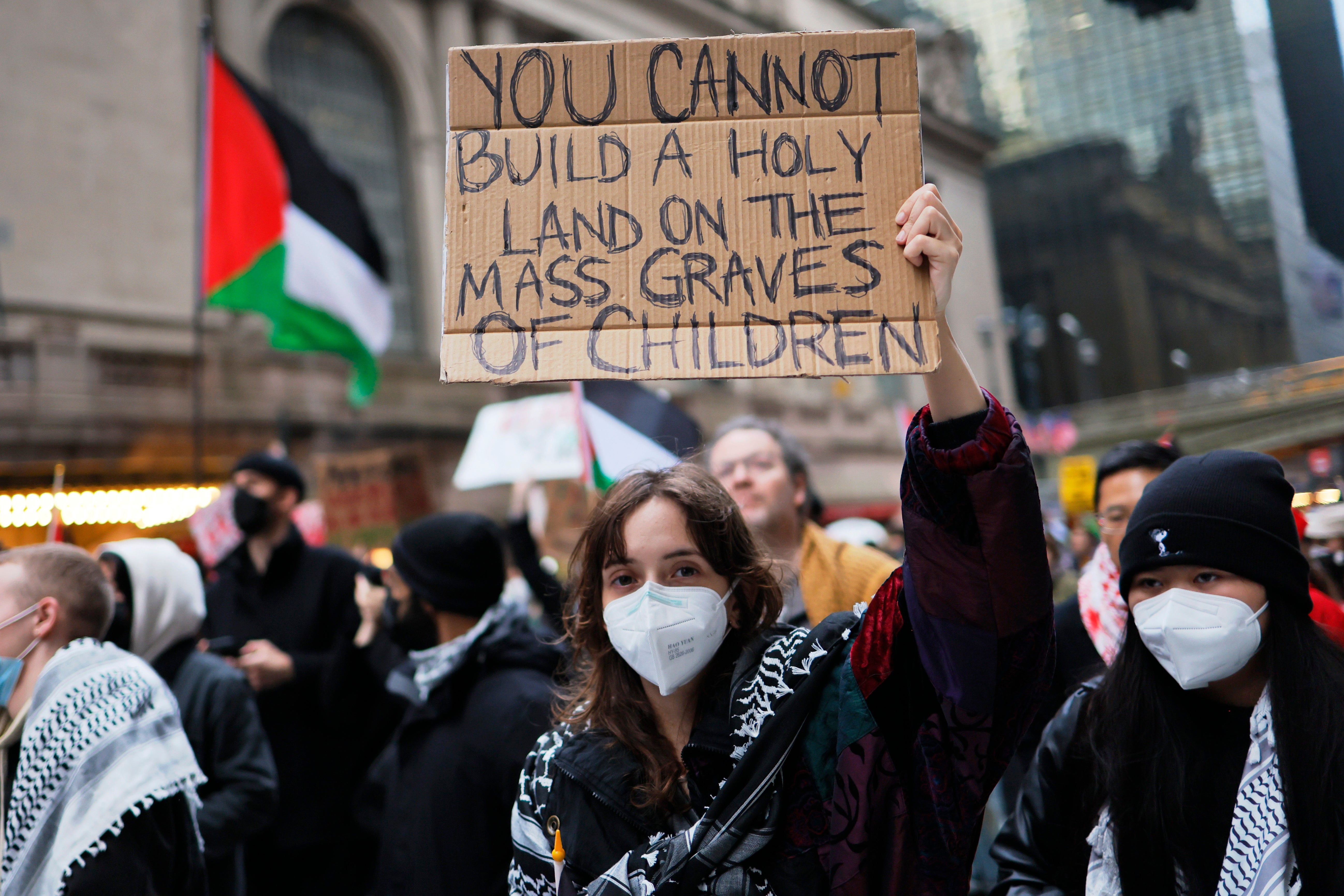 A person holds up a sign during a Pro-Palestine march to participate in a Global Strike for Gaza on 18 December 2023 in New York City, New York