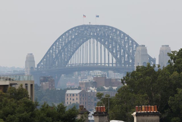 <p>A view of the Sydney Harbour Bridge shrouded in smog during bushfires in December </p>