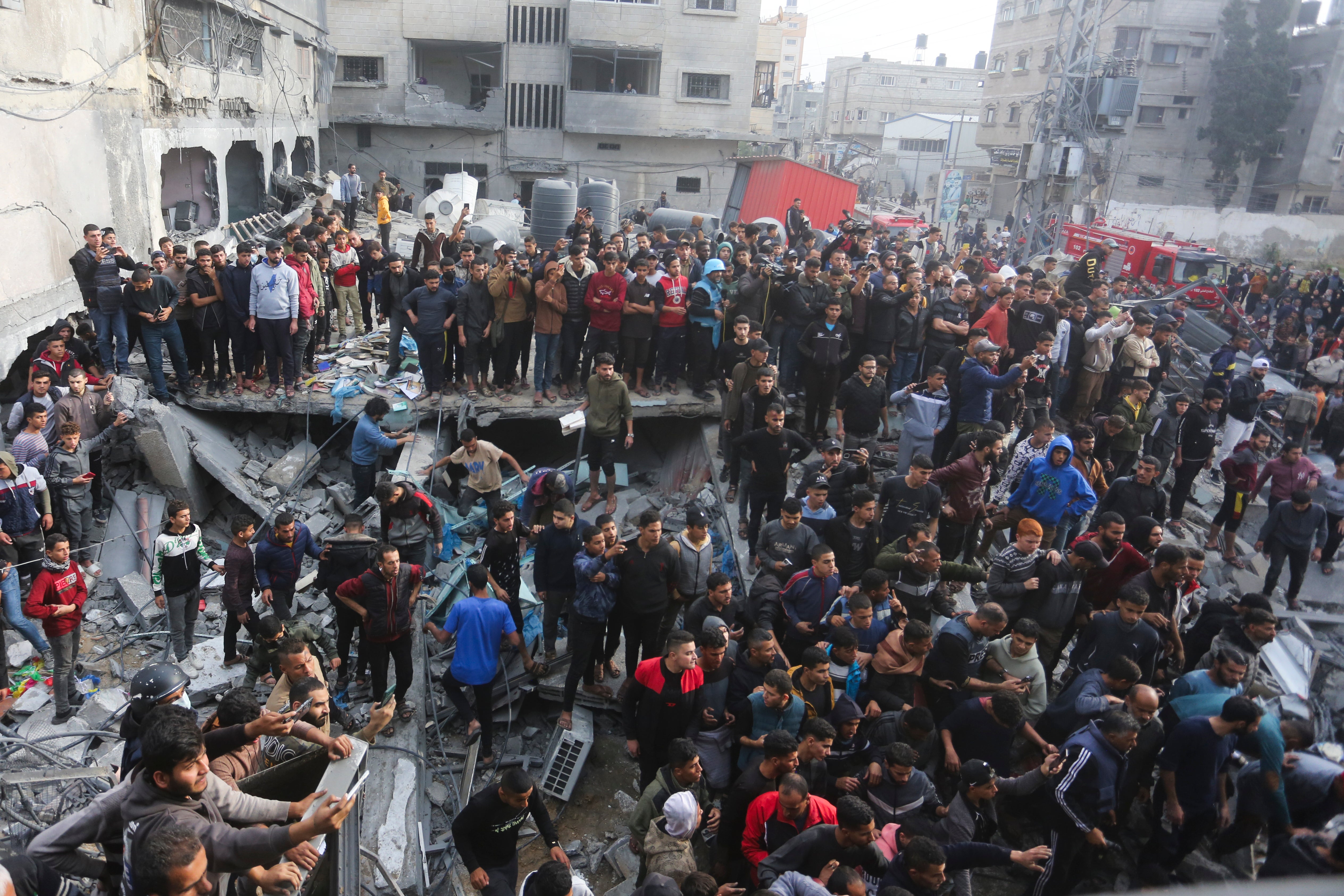Palestinians gather after an Israeli strike in Rafah, Gaza