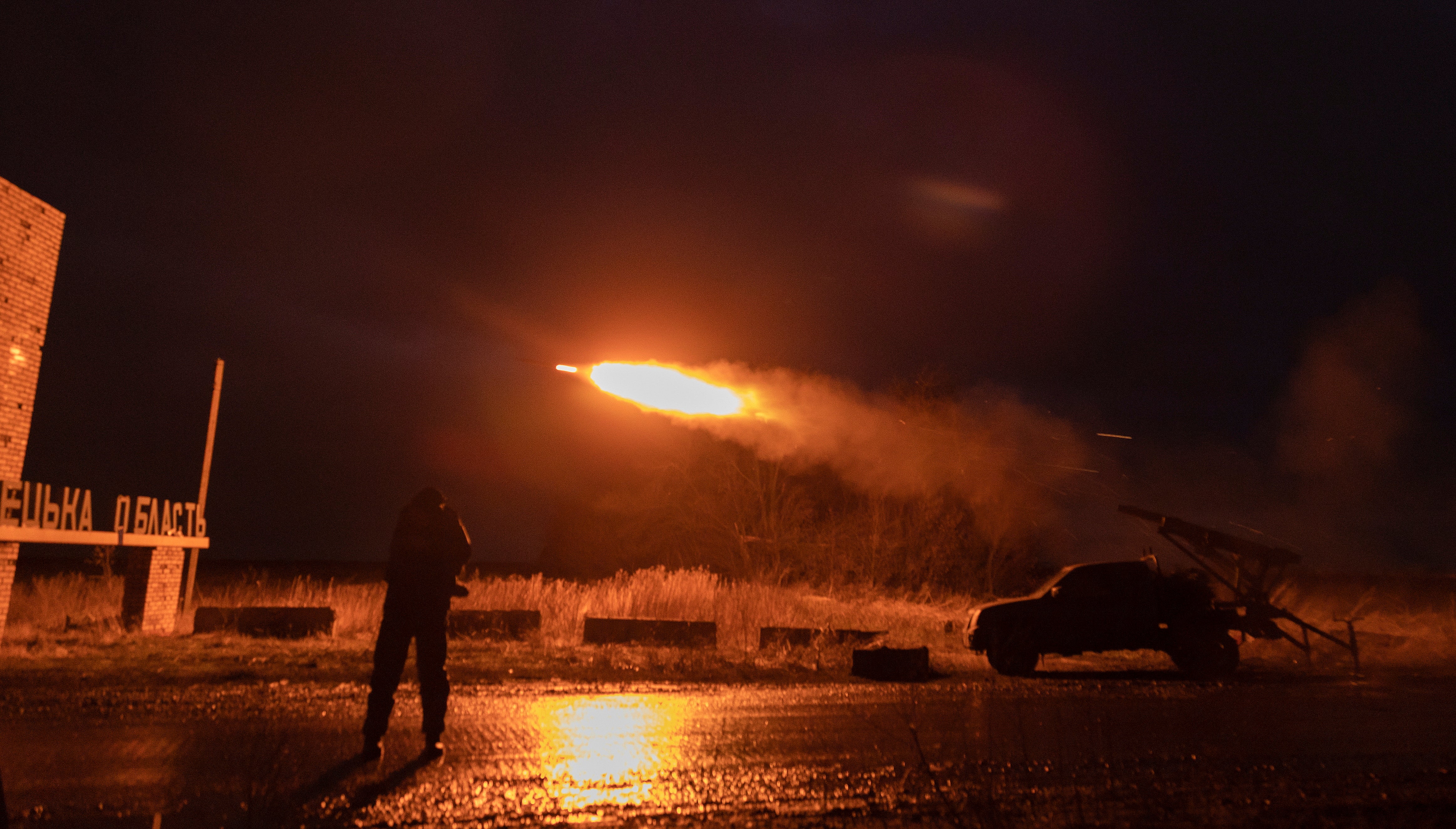 Ukrainian servicemen fire from a self-made multiple rocket launcher on a front line in Donetsk