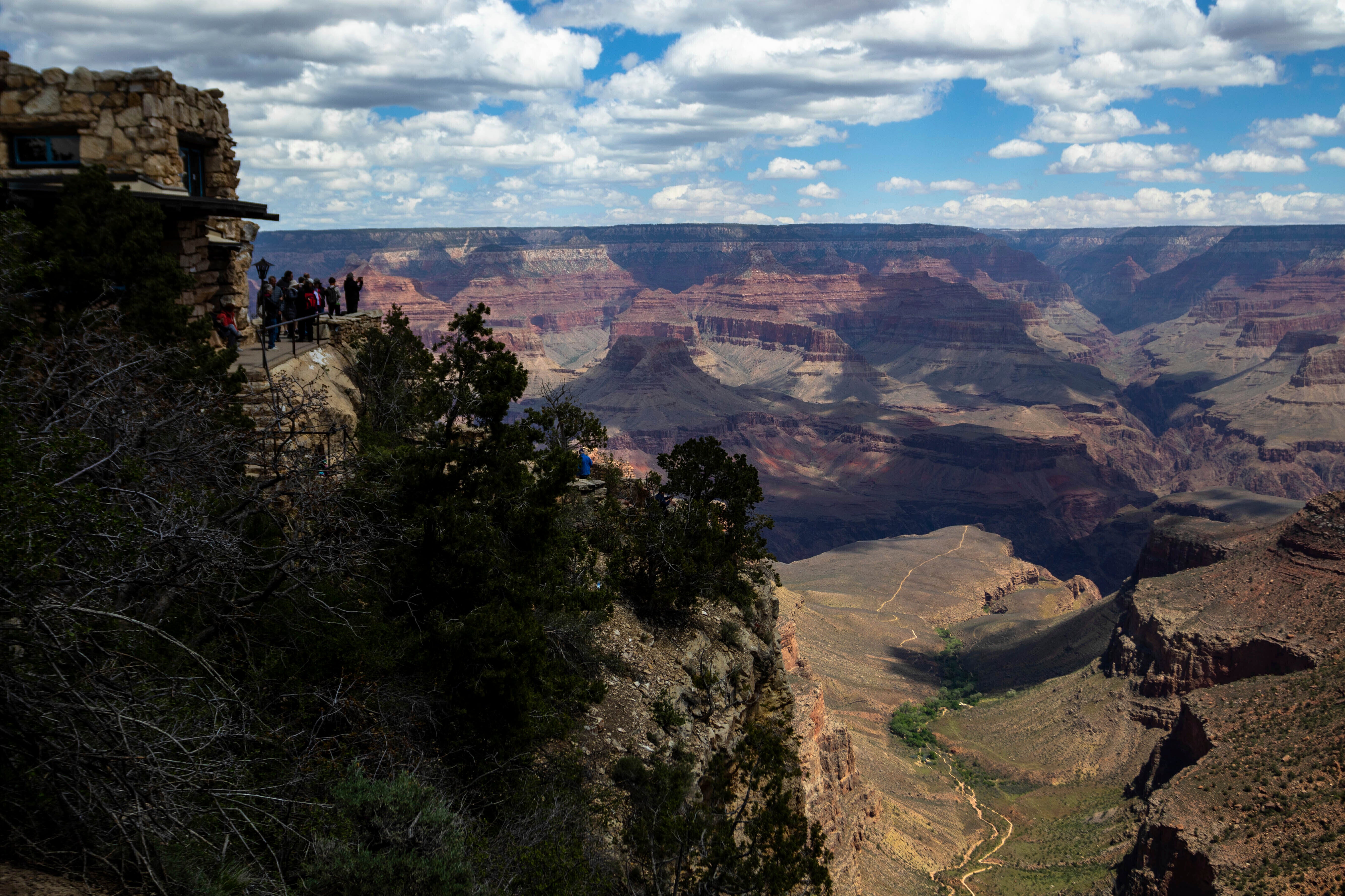 Tourists look out from the South Rim at the Grand Canyon, May 4, 2023