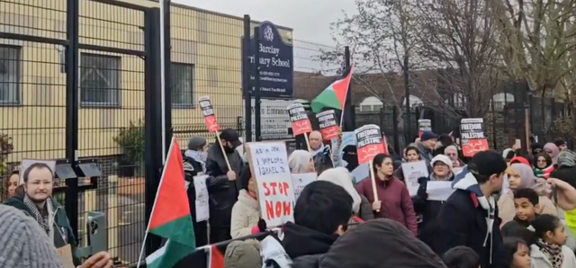 <p>Crowds chanted ‘education is under attack’ as parents gathered with pro-Palestine placards and banners</p>