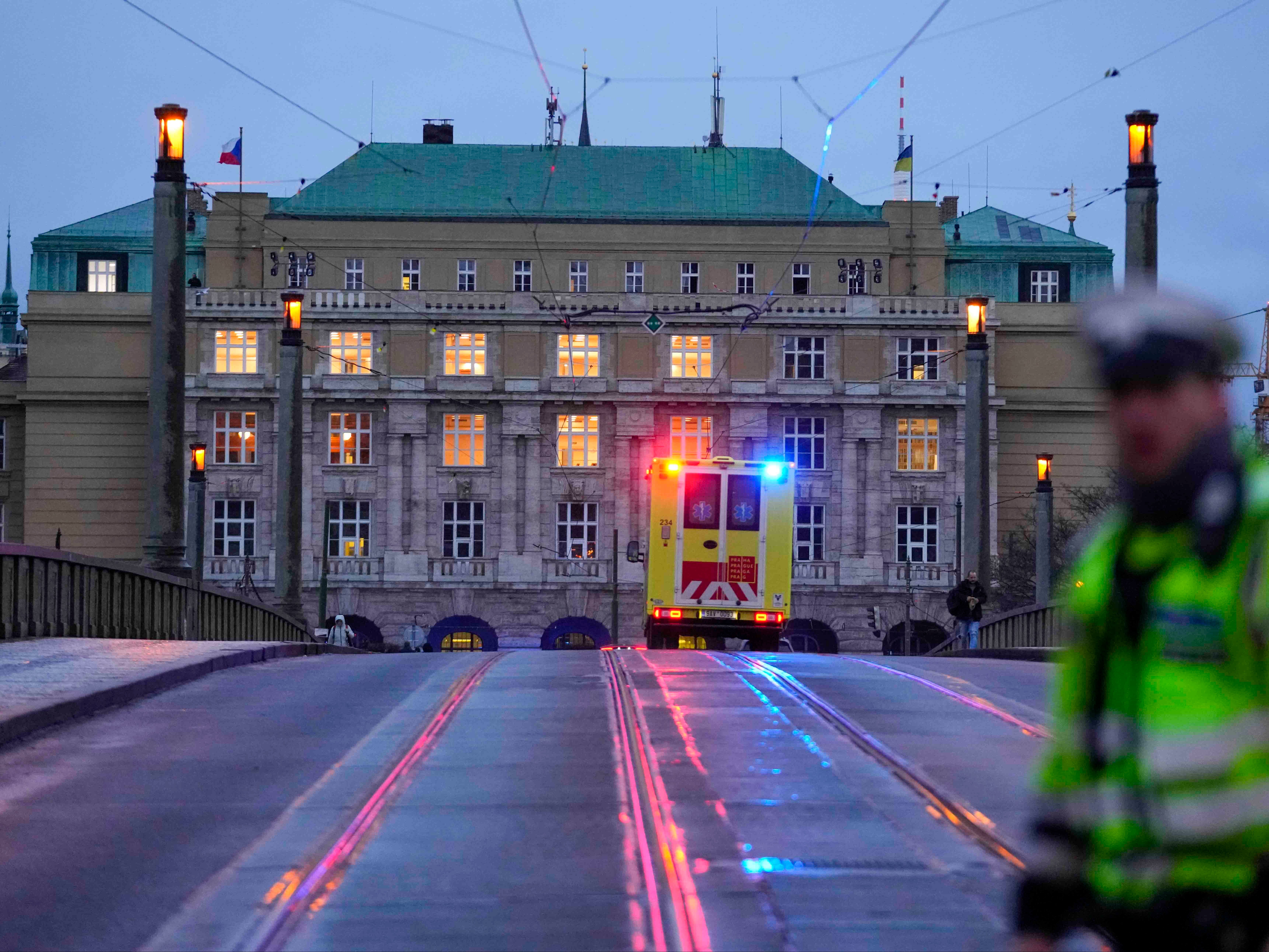 An ambulance drives towards the university in Prague