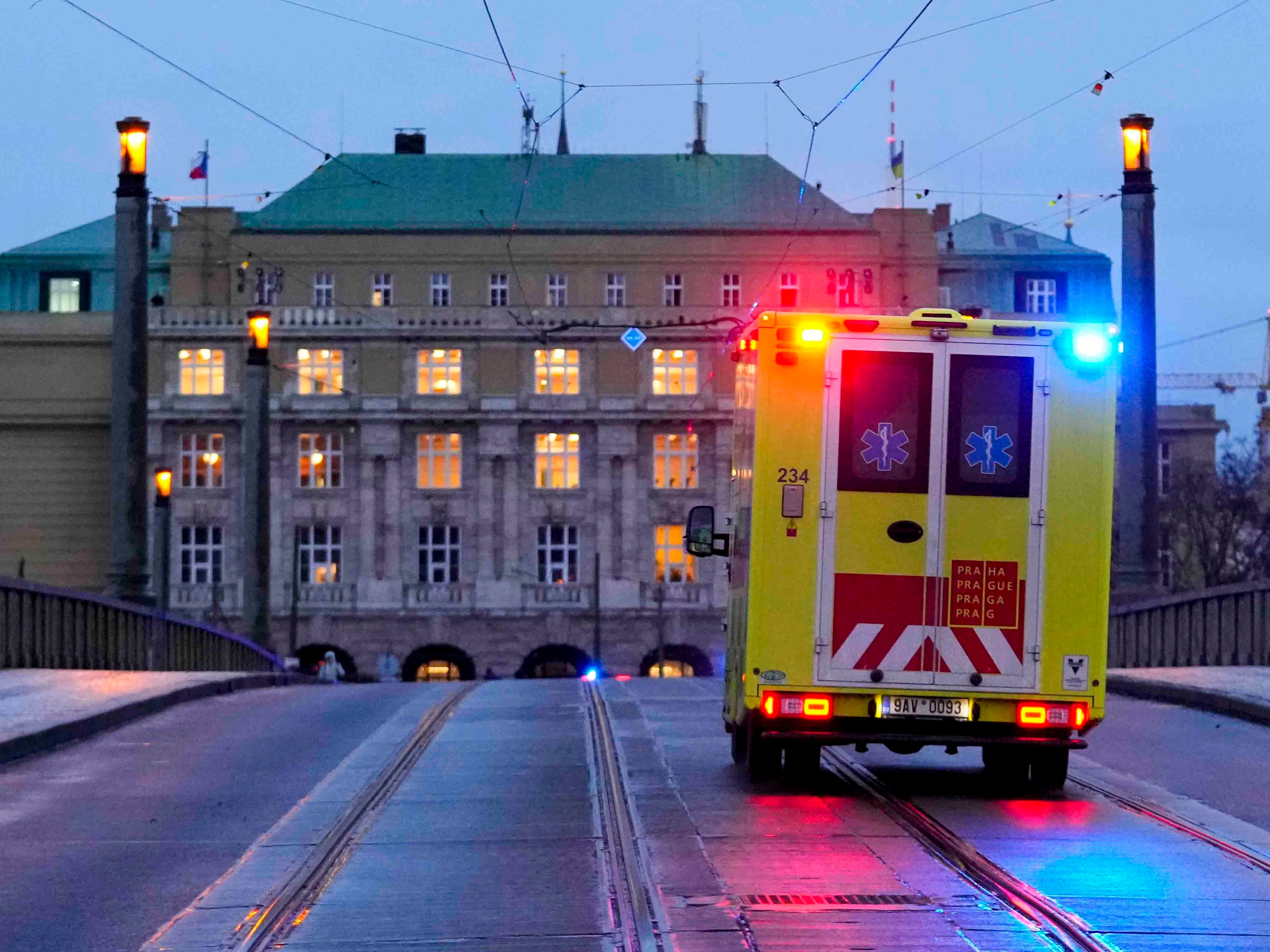 An ambulance drives towards the building of Philosophical Faculty of Charles University in Prague