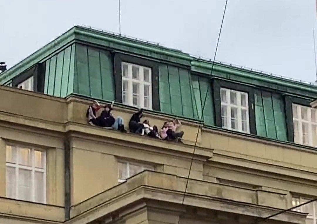 Images and videos on social media shows eight students perched on a ledge to hide from the gunman