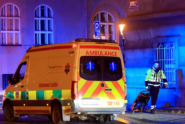 <p>A member of the emergency service at the scene of the shooting </p>