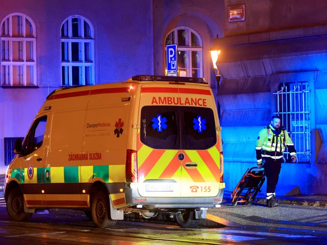 <p>A member of the emergency service at the scene of the shooting </p>