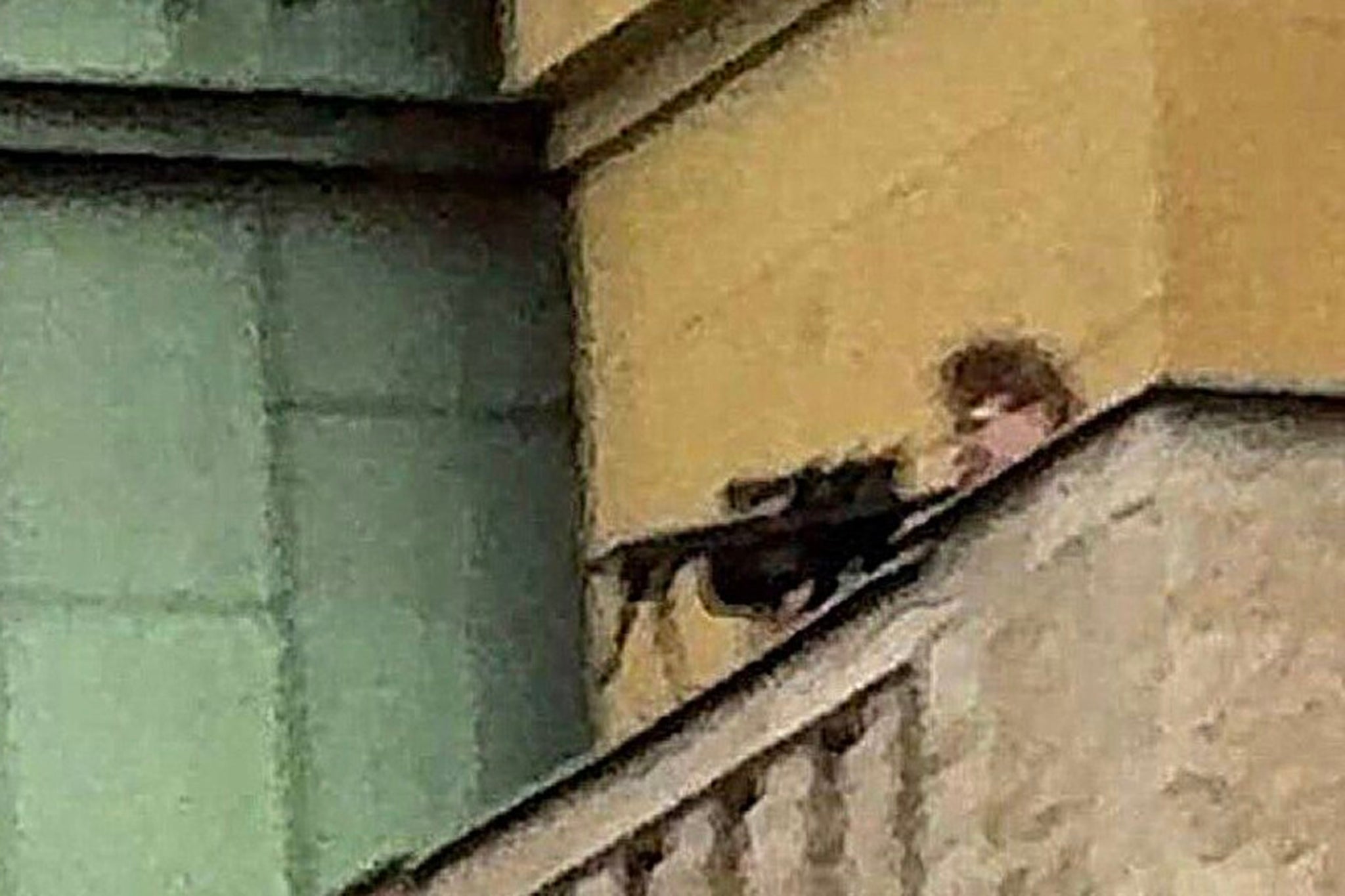 Kozak pointing a rifle at the square below