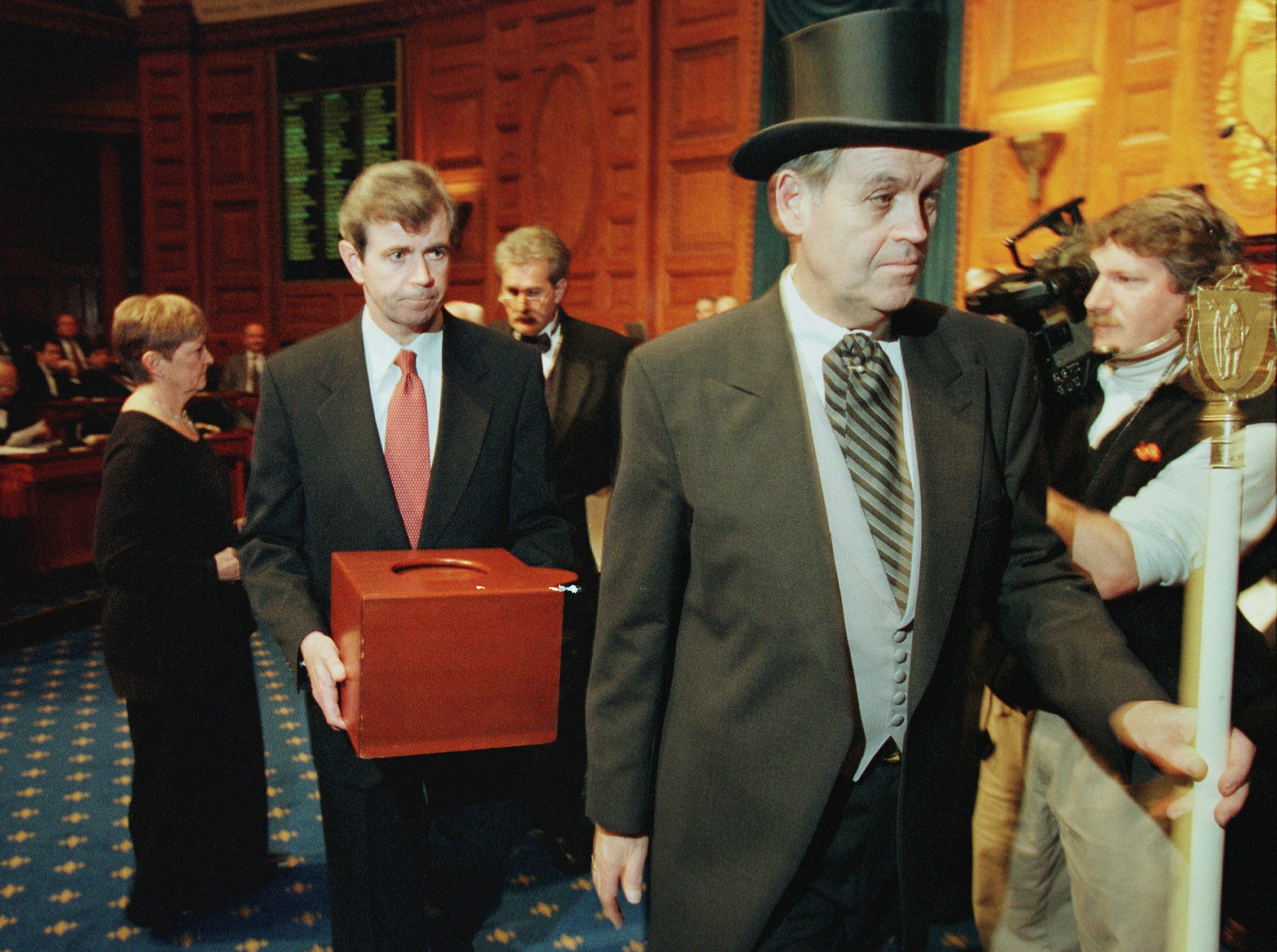Massachusetts Secretary of the Commonwealth William Galvin, centre, carries a ballot box containing the 12 Massachusetts electoral votes for Vice President Al Gore as he is led by Sergeant-at Arms Michael Rea, right, during the Electoral College voting at the Statehouse on 18 December 2000 in Boston