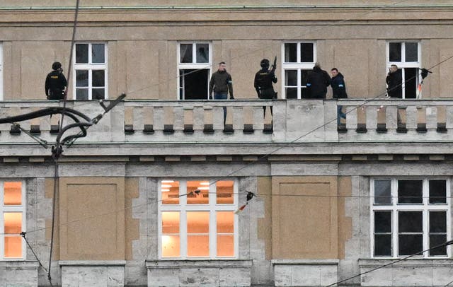 <p>Armed police are seen on the balcony of the Charles University in central Prague</p>