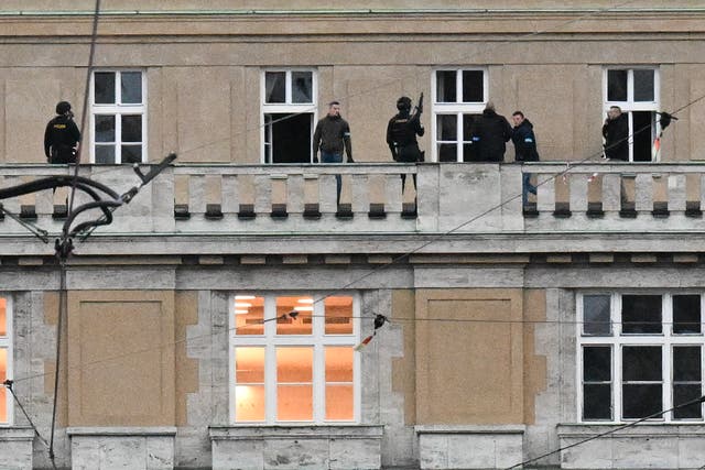 <p>Armed police are seen on the balcony of the Charles University in central Prague</p>