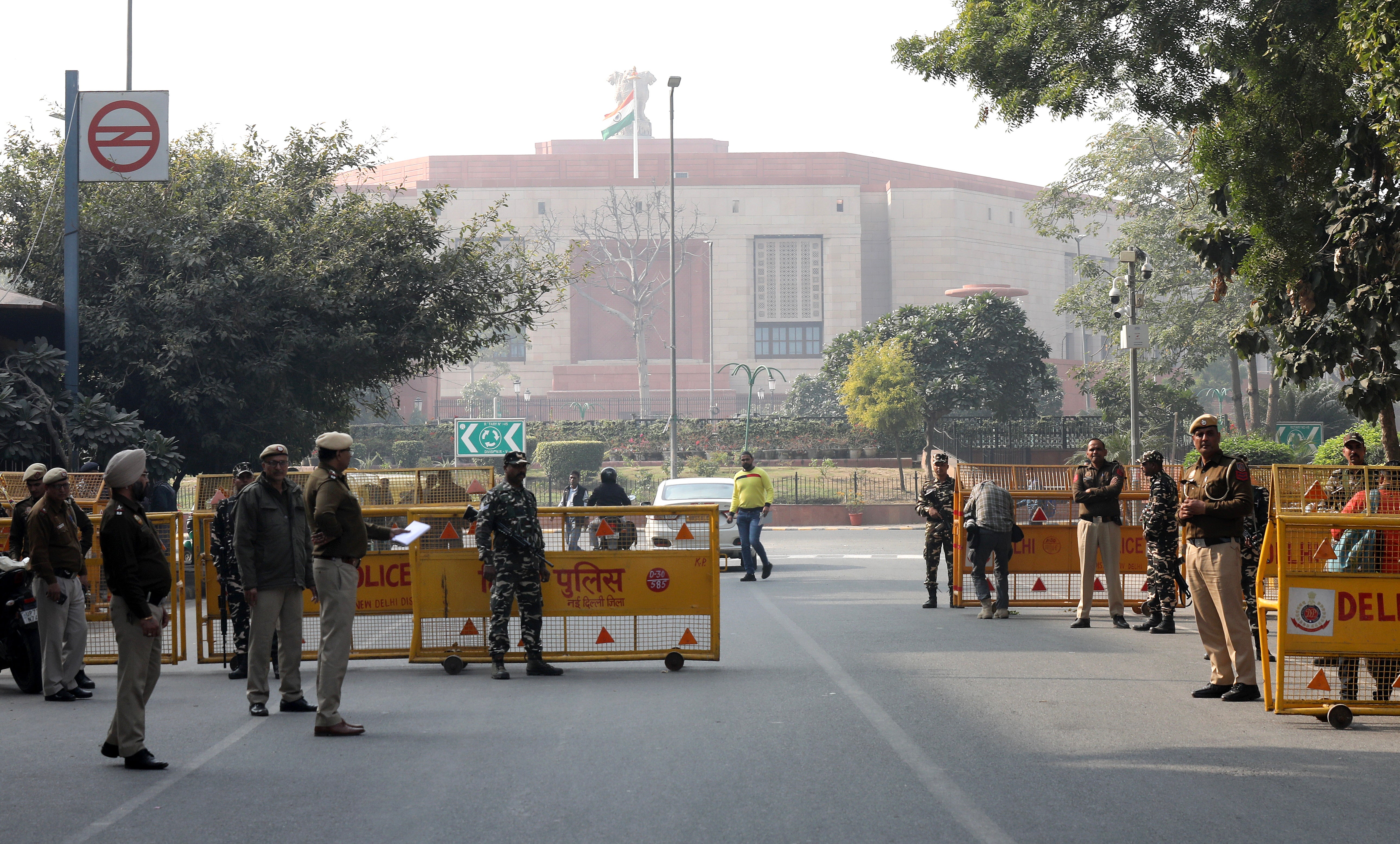 Indian Security personnel and Delhi police members check people and vehicles heading towards the Parliament House in New Delhi, India, 13 December 2023