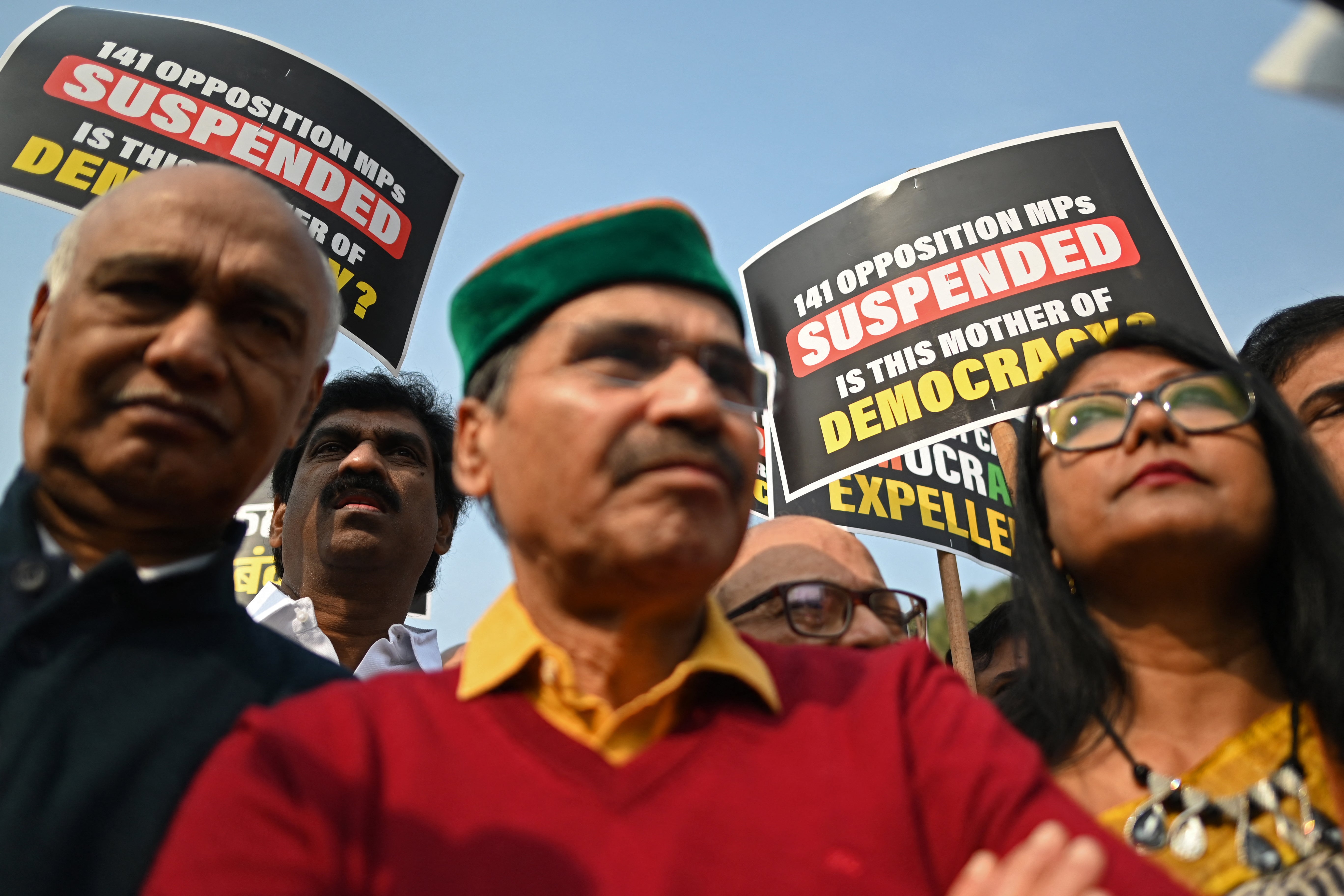 Members of Parliament hold placards as they take part in a protest march in New Delhi on 21 December 2023, against the suspension of lawmakers belonging to an opposition grouping of 26 parties dubbed INDIA