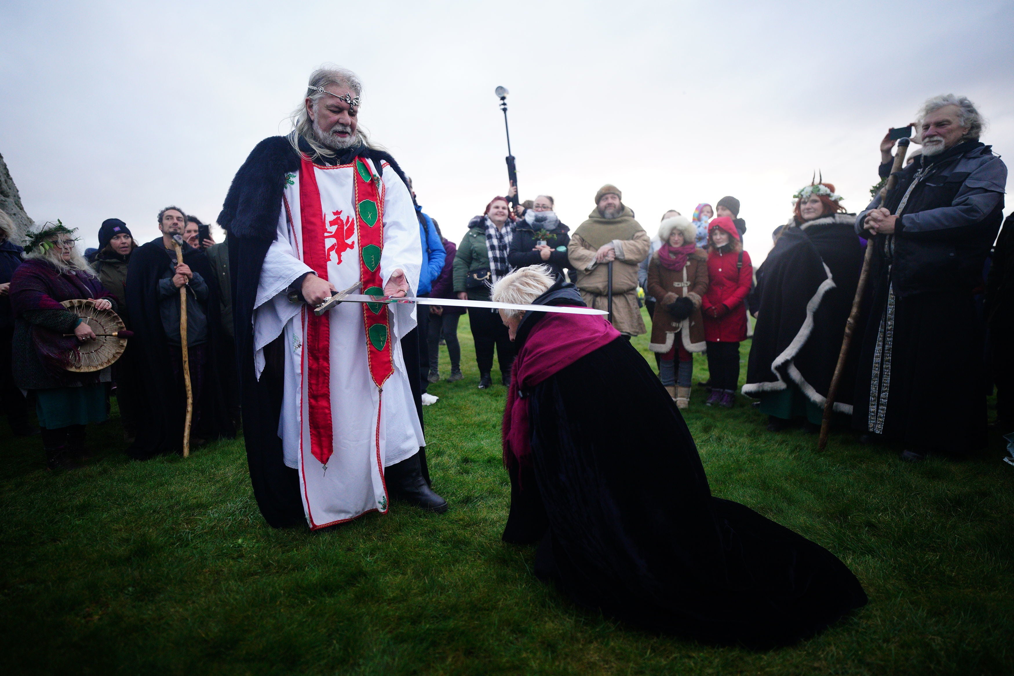 A self-proclaimed incarnation of King Arthur, Arthur Pendragon, knights his followers at Stonehenge