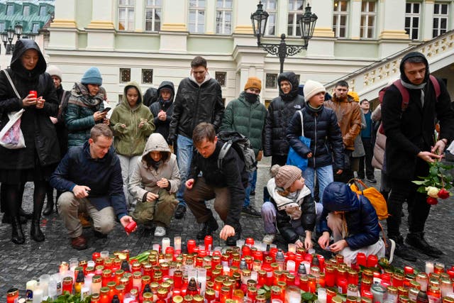 <p>Mourners lay candles outside the Charles University building where Thursday’s attack took place</p>