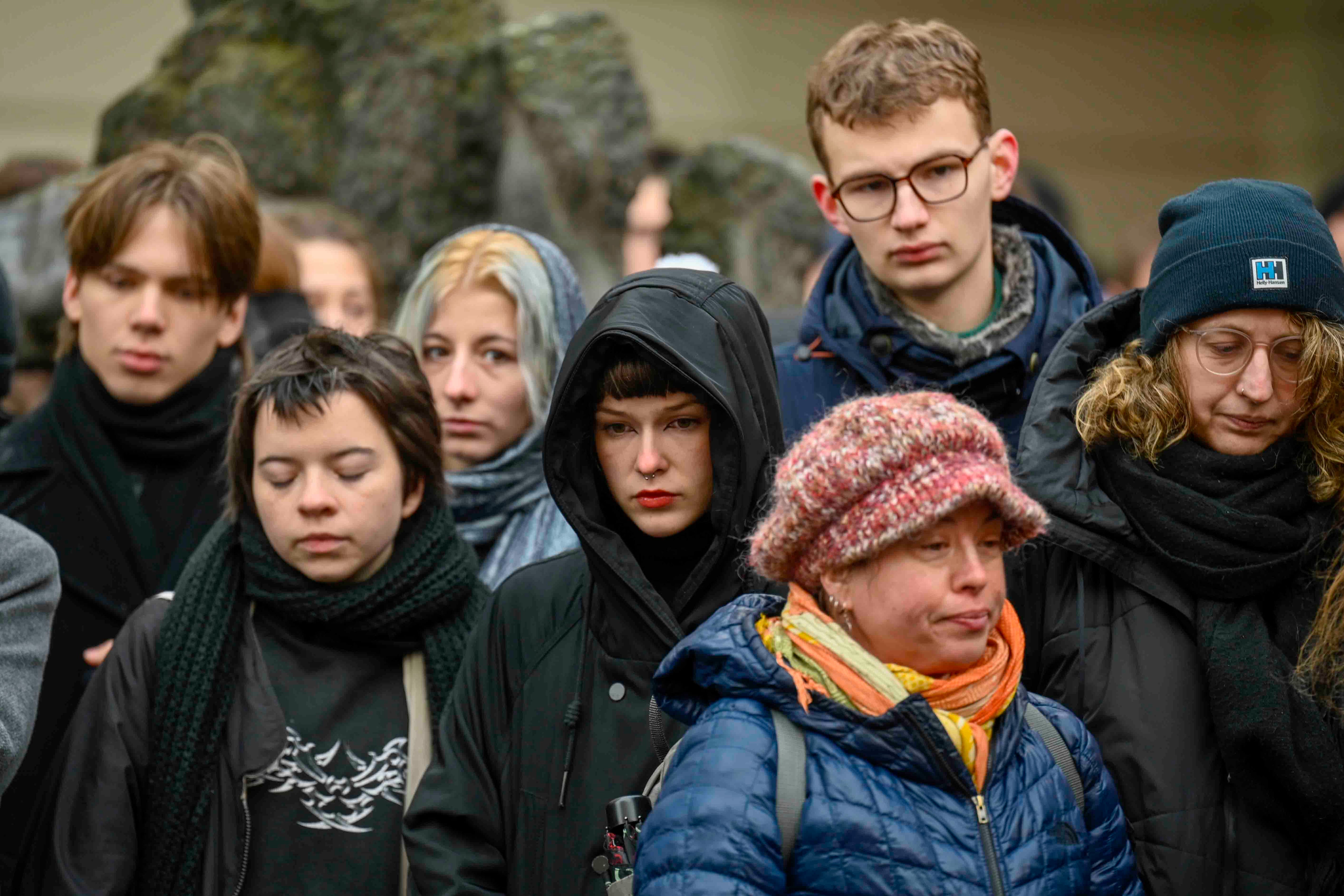 Mourners stand outside the headquarters of Charles University after the mass shooting