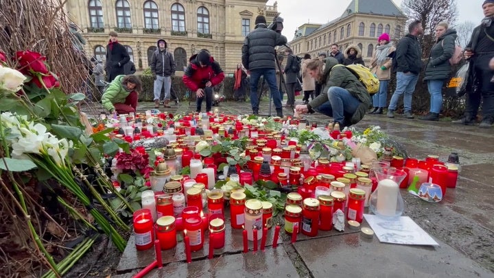 Mourners lay flowers outside the university building where Kozak carried out the killing