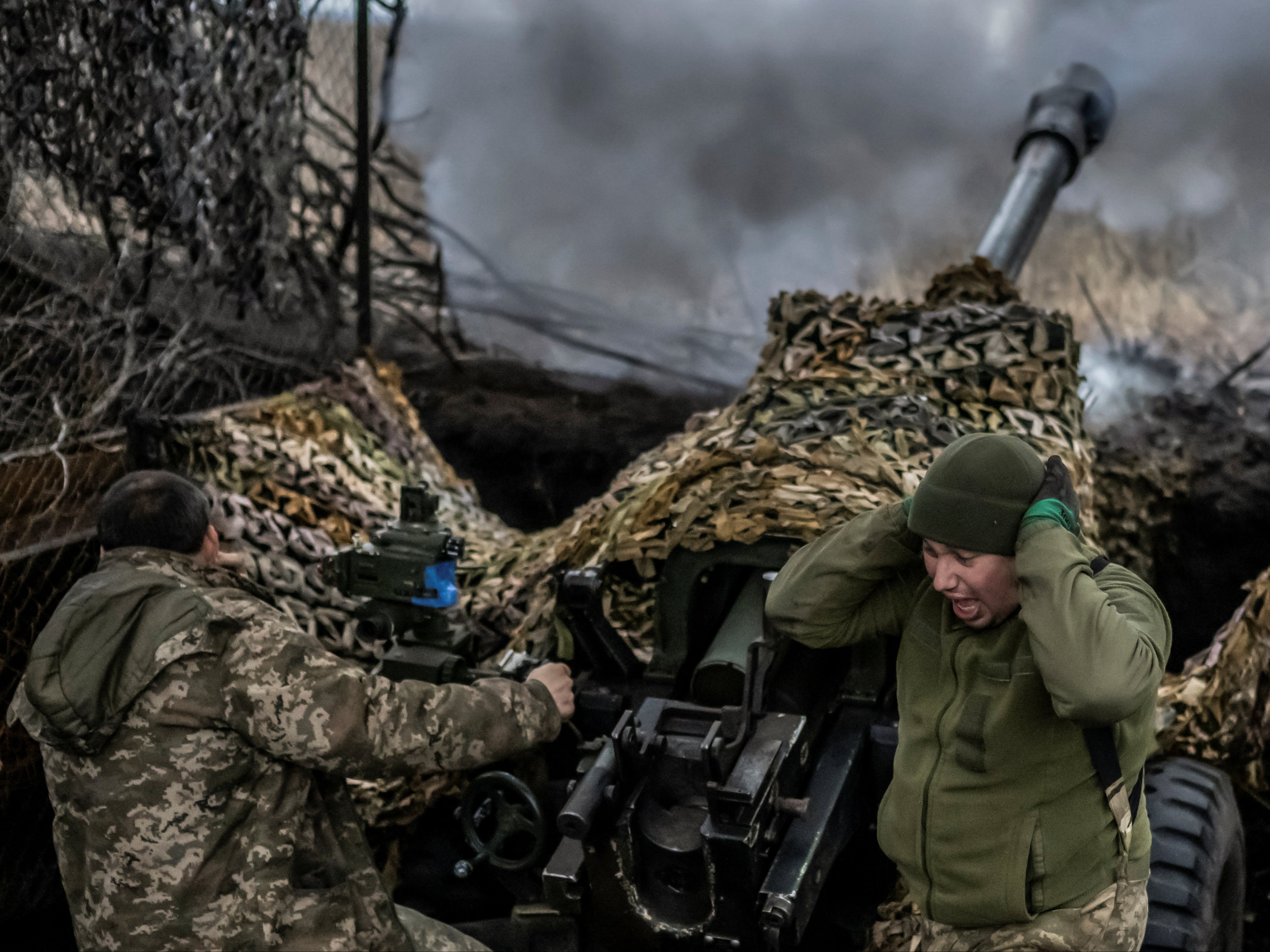 Ukrainian troops fire an L119 howitzer towards Russian forces, near the frontline town of Bakhmut