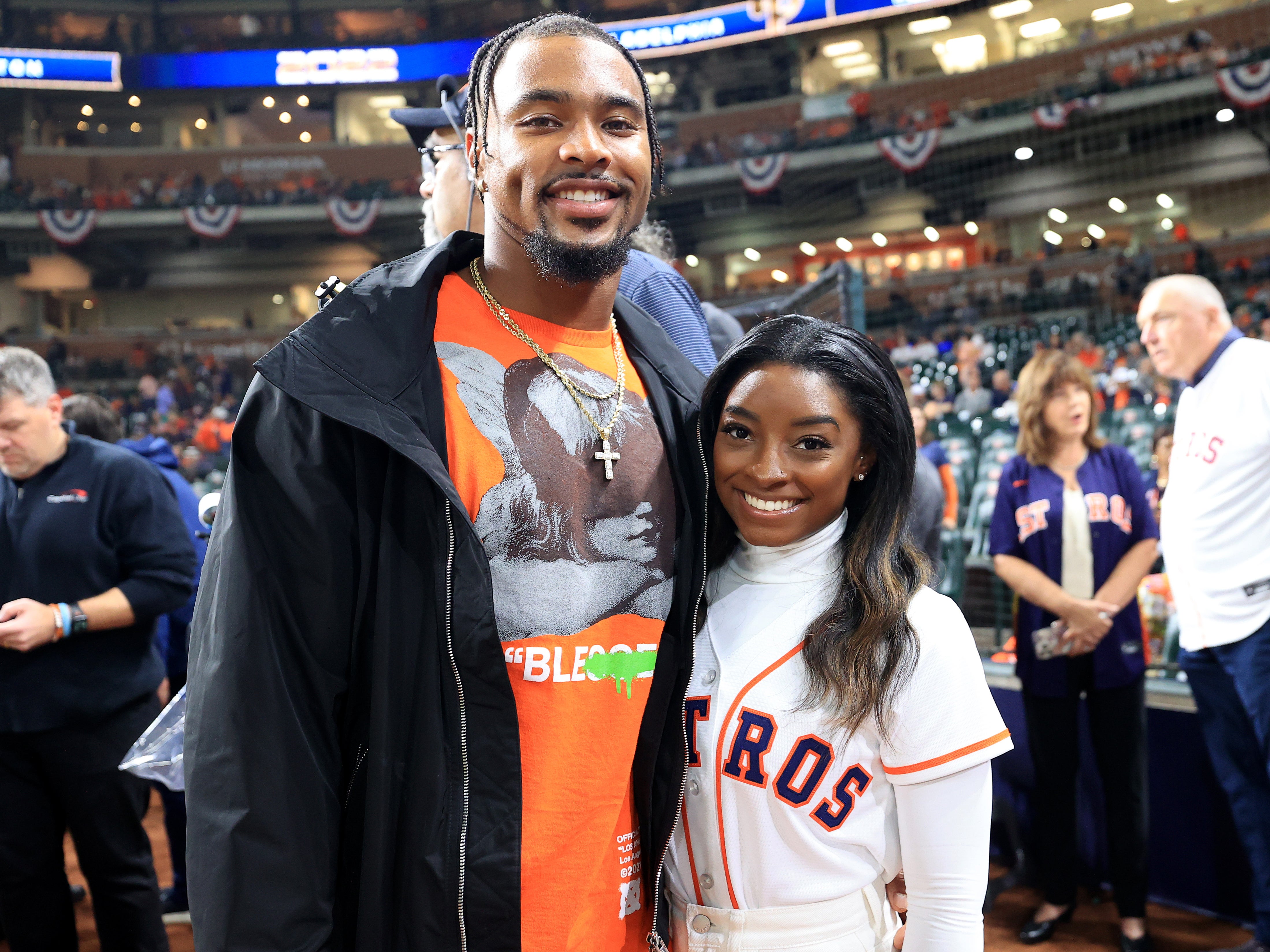 Simone Biles and Jonathan Owens pose on the field prior to Game One of the 2022 World Series between the Philadelphia Phillies and the Houston Astros at Minute Maid Park on 28 October 2022 in Houston, Texas