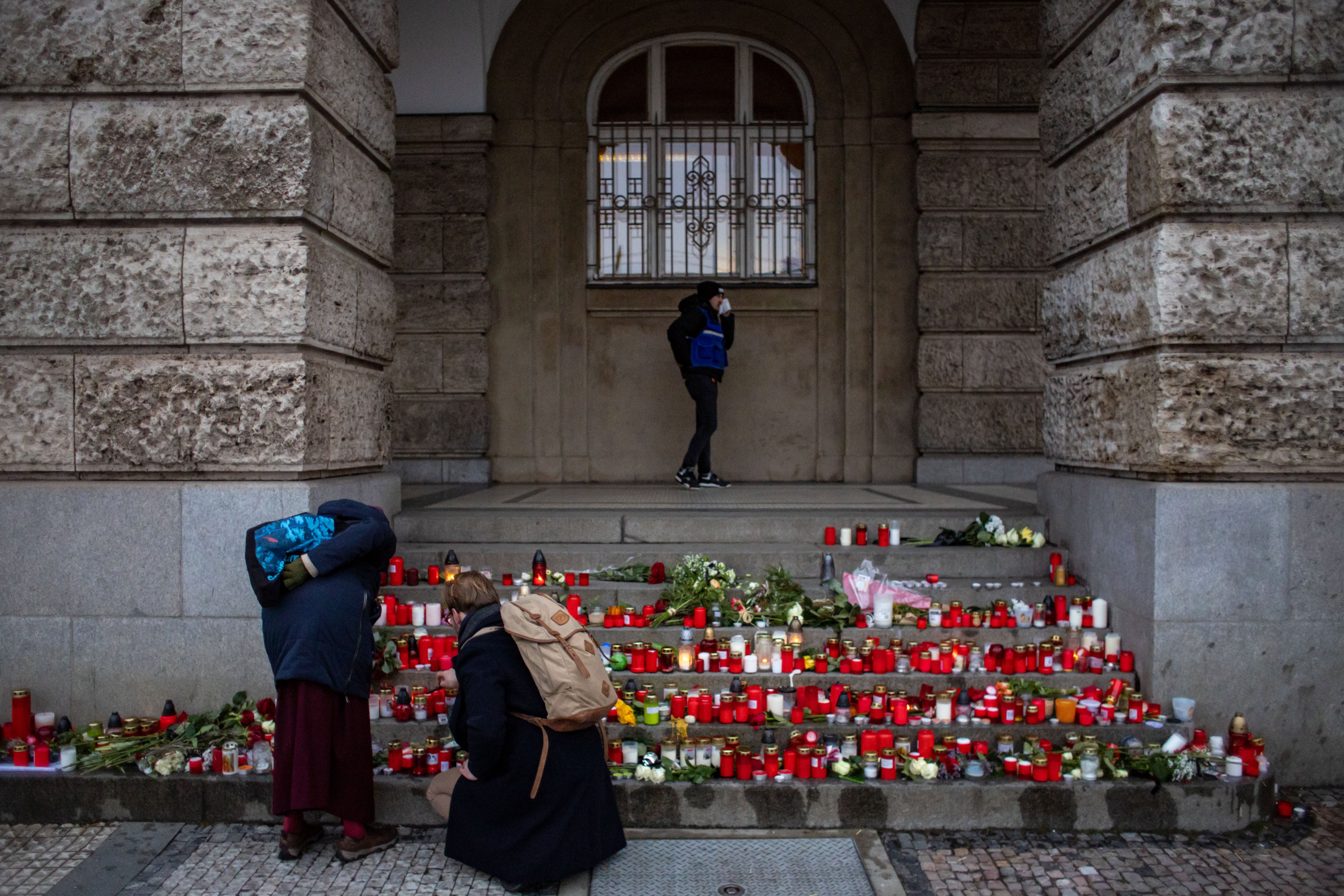 People pay respects outside the Philosophical Faculty of Charles University following a mass shooting, during the day of national mourning in central Prague, Czech Republic, on Saturday