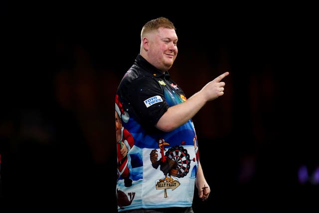 Ricky Evans celebrates victory over Nathan Aspinall in round two (John Walton/PA)