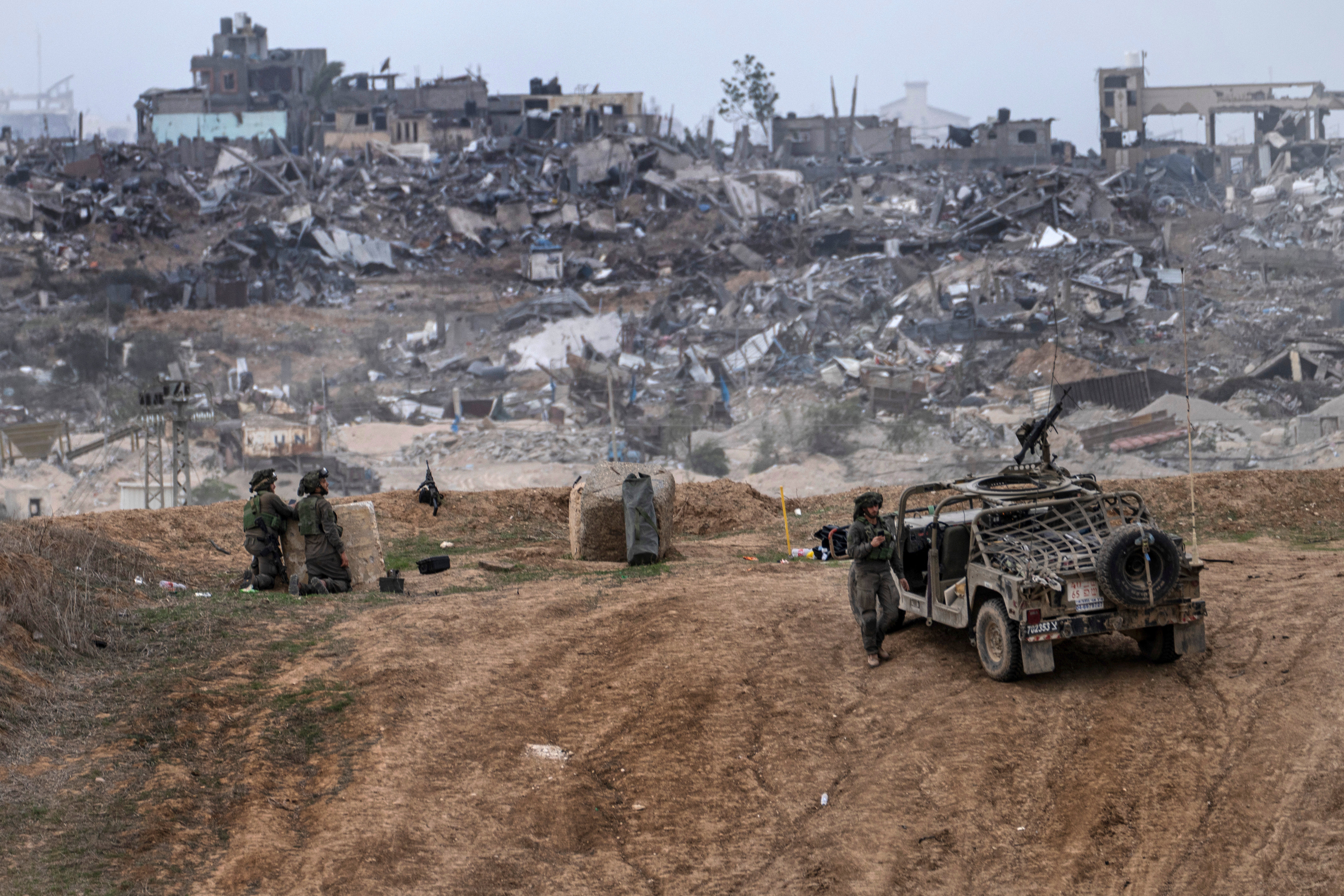 Israeli army vehicles and soldiers are seen near the Gaza Strip border, in southern Israel