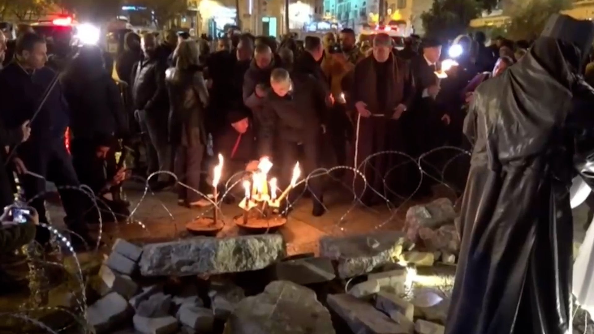 <p>Nativity scene in Bethlehem created with rubble and razor wire</p>