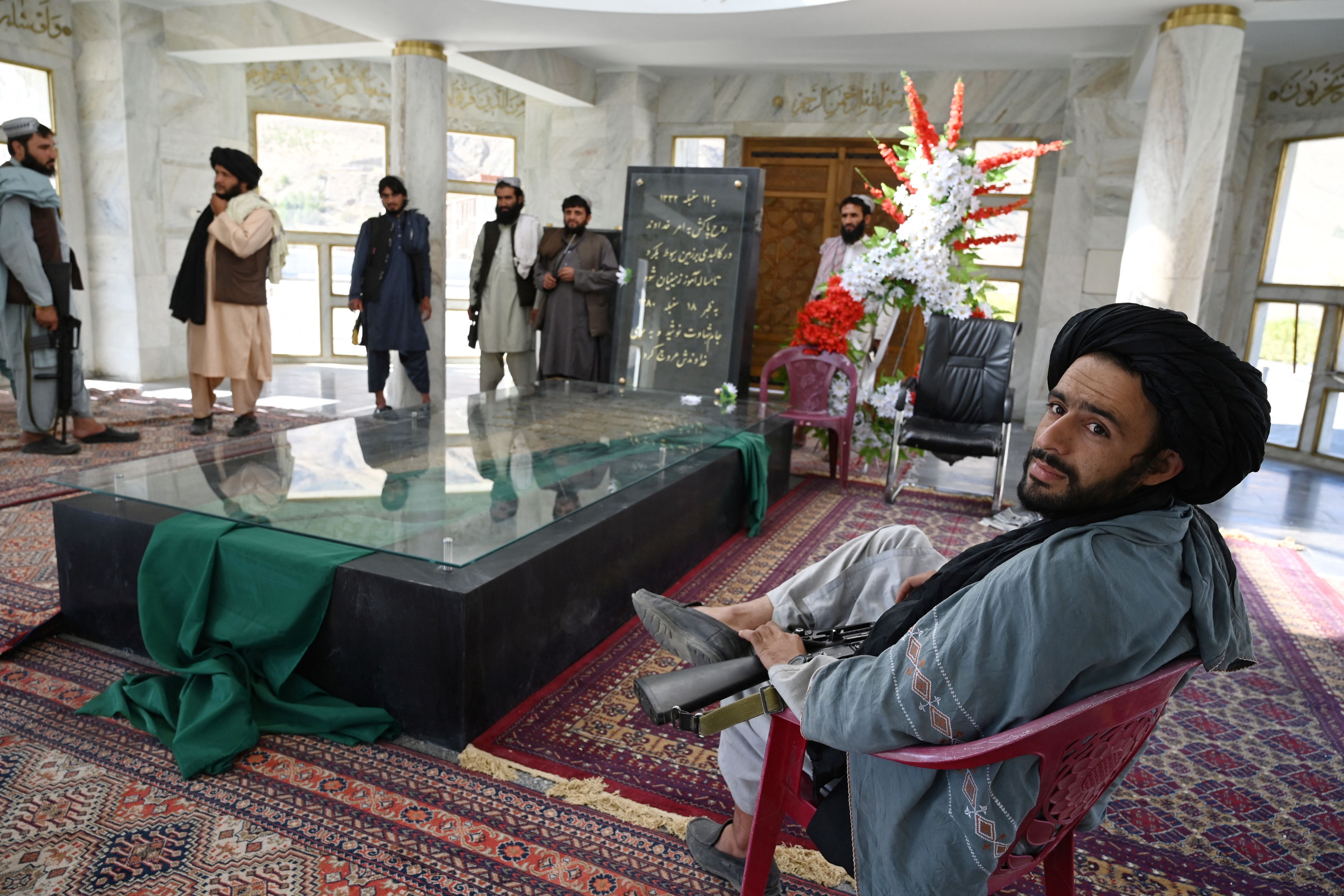 Taliban fighters stand near the tomb of late Afghan Mujahideen leader Ahmad Shah Massoud in Saricha in Panjshir province