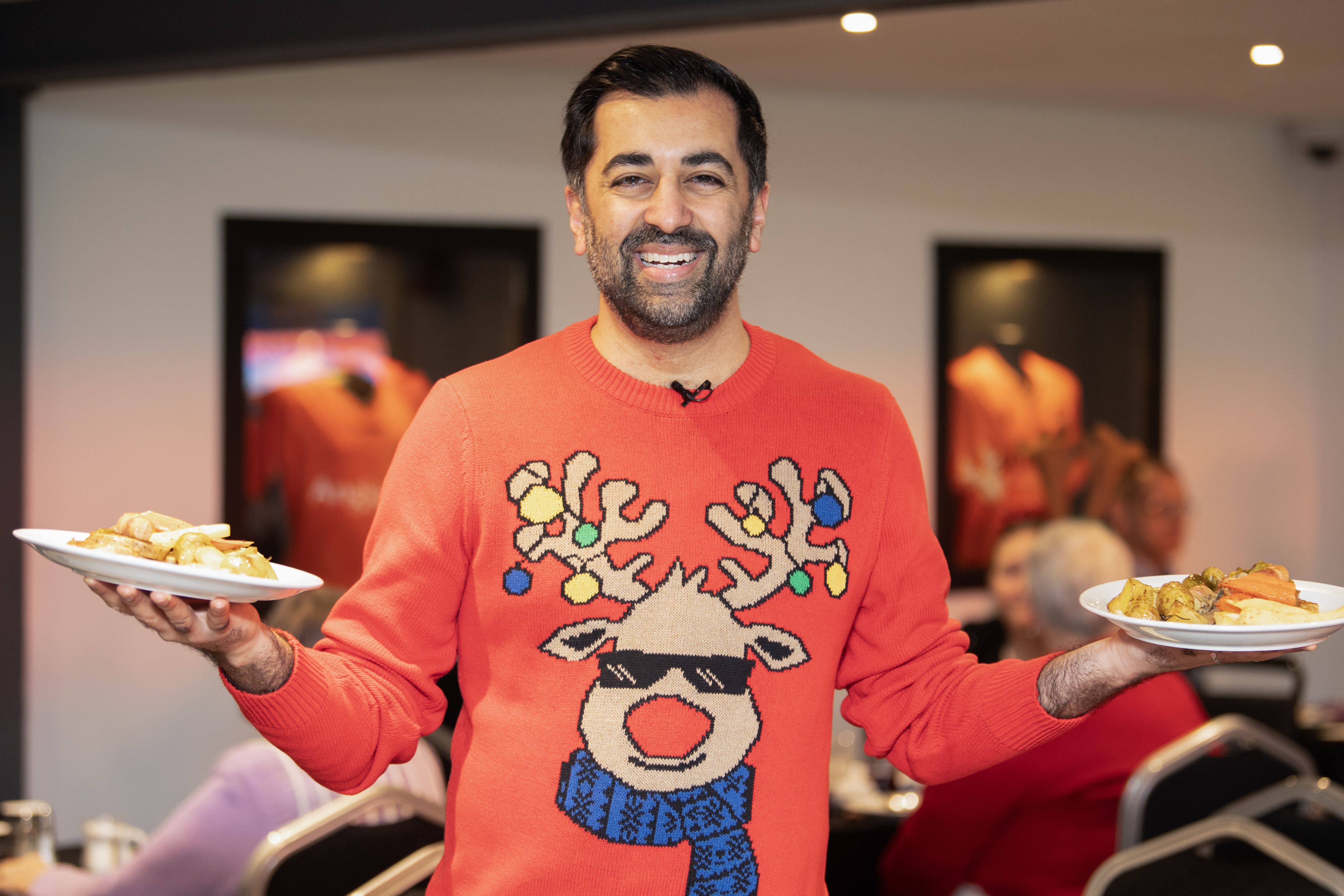 First Minister of Scotland Humza Yousaf, serves lunch to older people who are at risk of isolation and loneliness over the festive period, during a visit to Dundee United Community Trust’s Festive Friends, in Dundee (Lesley Martin/PA)