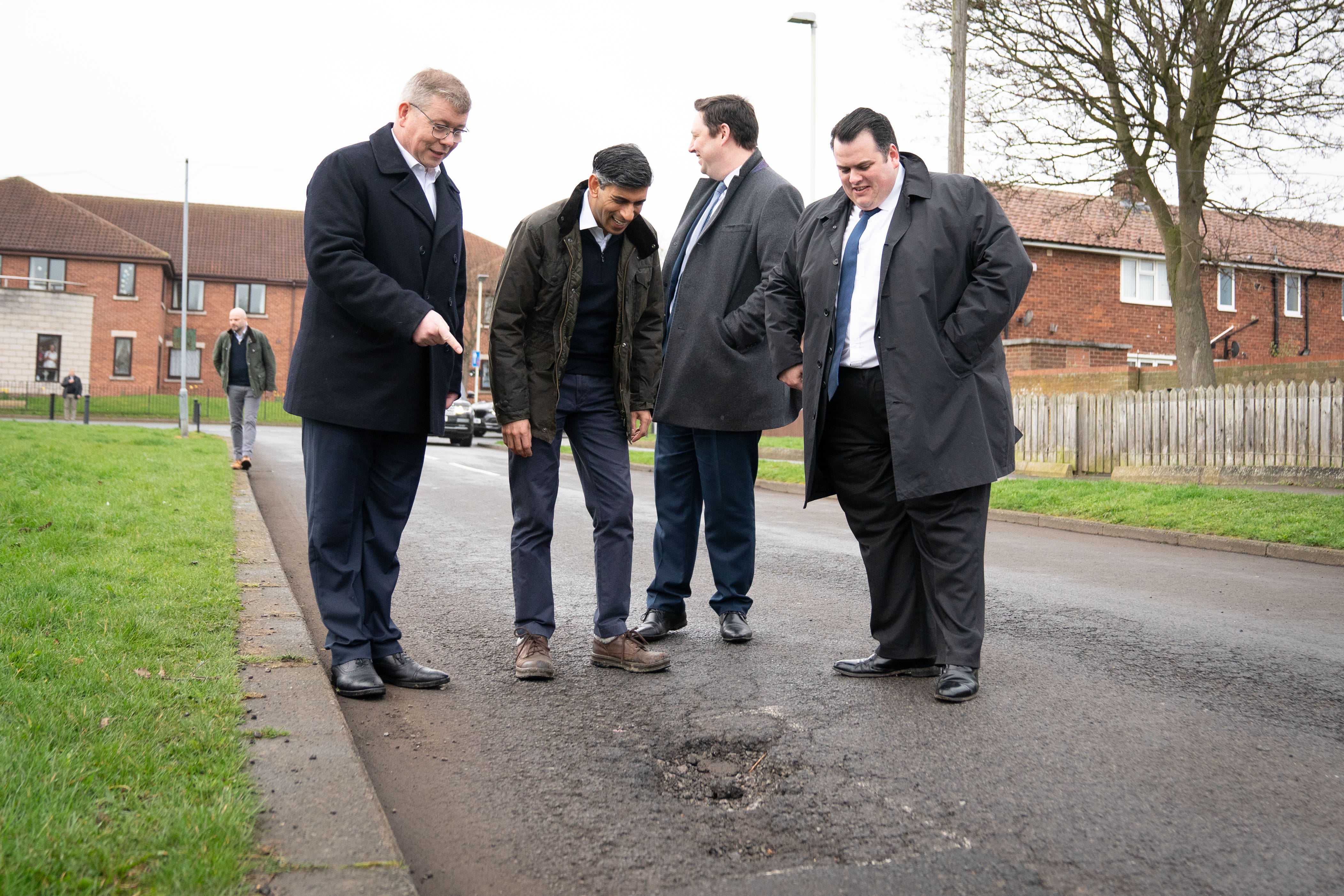Prime Minister Rishi Sunak looks at a pothole in Darlington (Stefan Rousseau/PA)