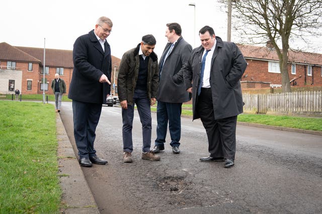 <p>Prime Minister Rishi Sunak looks at a pothole in Darlington (Stefan Rousseau/PA)</p>