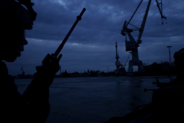 <p>FILE: A Ukraine Special Operations Forces officer talks on the radio while navigating the Dnipro River during a night mission in Kherson region, in Kherson, Ukraine, 11 June 2023</p>