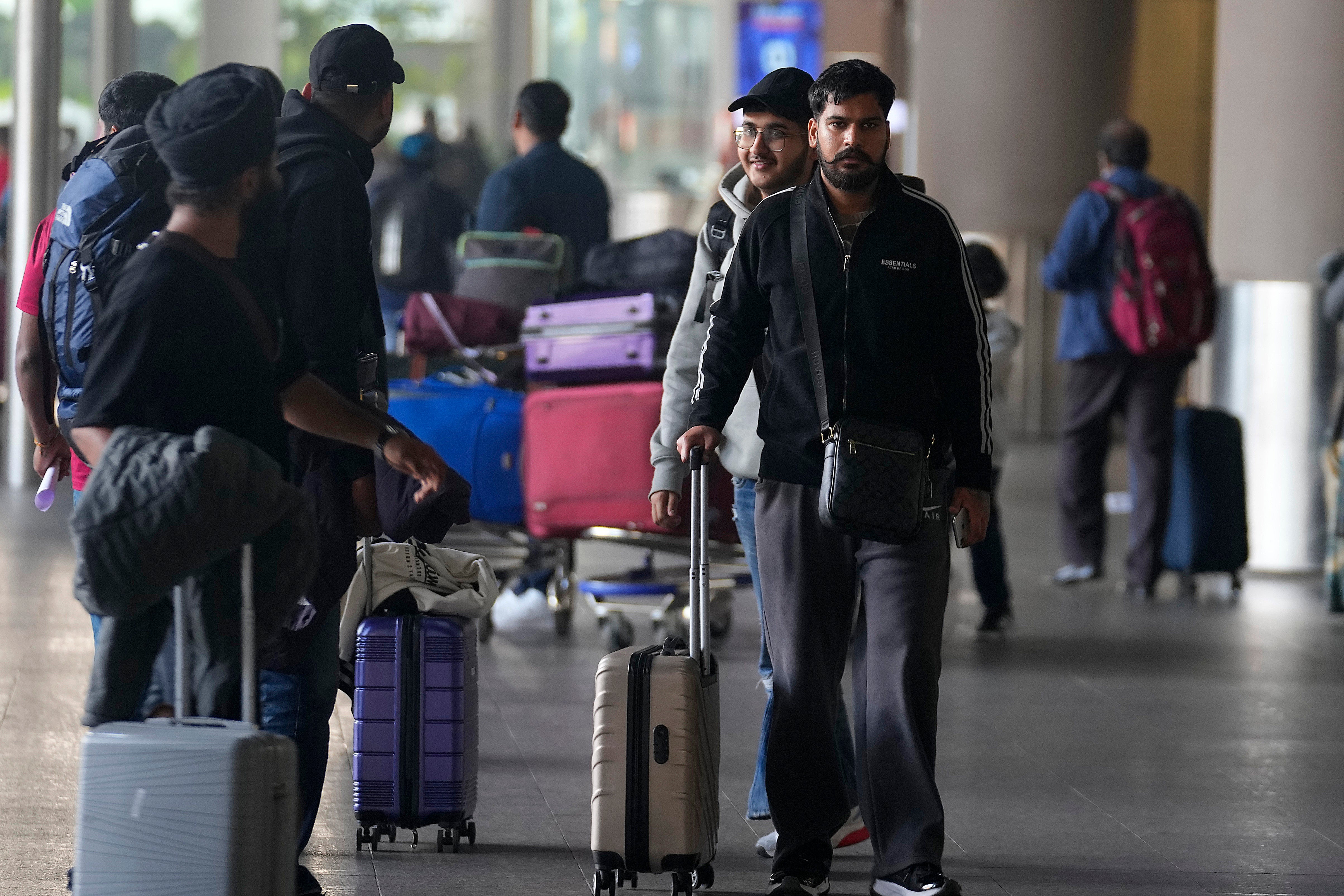 Indian passengers who travelled to France on a Legend Airlines Airbus A340 arrive at an airport in Mumbai after their flight was grounded in France for four days