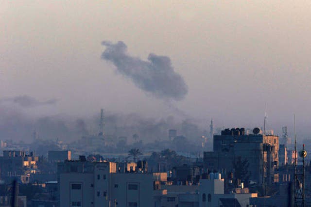 <p>A picture taken from Rafah shows smoke billowing over Khan Younis in the southern Gaza Strip during Israeli bombardment on 26 December 2023</p>